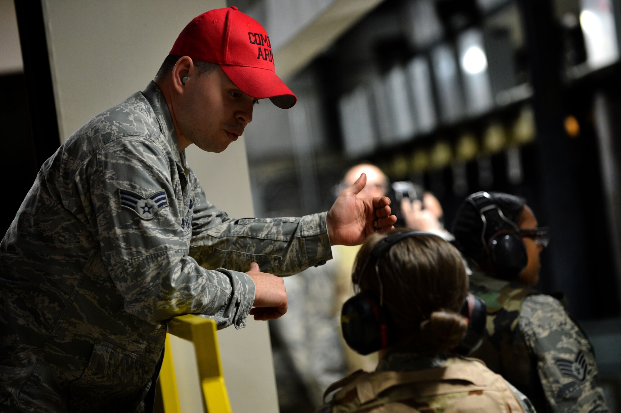 U.S. Air Force Senior Airman Robert Riley, 20th Security Forces Squadron combat arms instructor, gives directions to a Team Shaw member before firing an M4 carbine during combat arms training at Shaw Air Force Base, S.C., March 8, 2016. CATM instructors are in charge of ensuring that service members qualify on shooting various weapons before they deploy or leave Shaw. (U.S. Air Force photo by Senior Airman Michael Cossaboom)