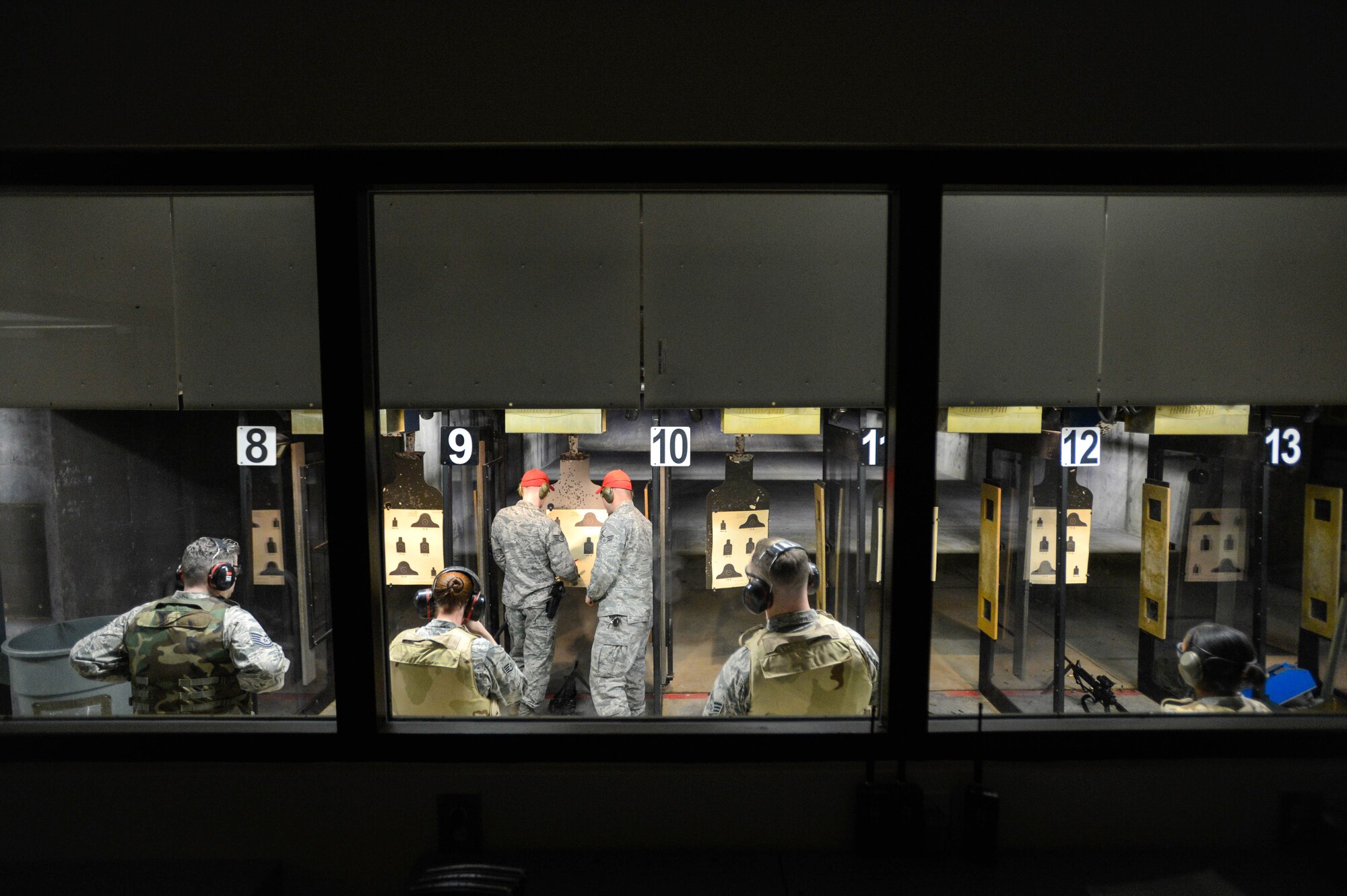 Combat arms instructors assigned to the 20th Security Forces Squadron review a target after live-firing at Shaw Air Force Base, S.C., March 8, 2016. In 2015, more than 420,000 bullets were fired at the range as Team Shaw members qualified on various weapons. (U.S. Air Force photo by Senior Airman Jensen Stidham) 