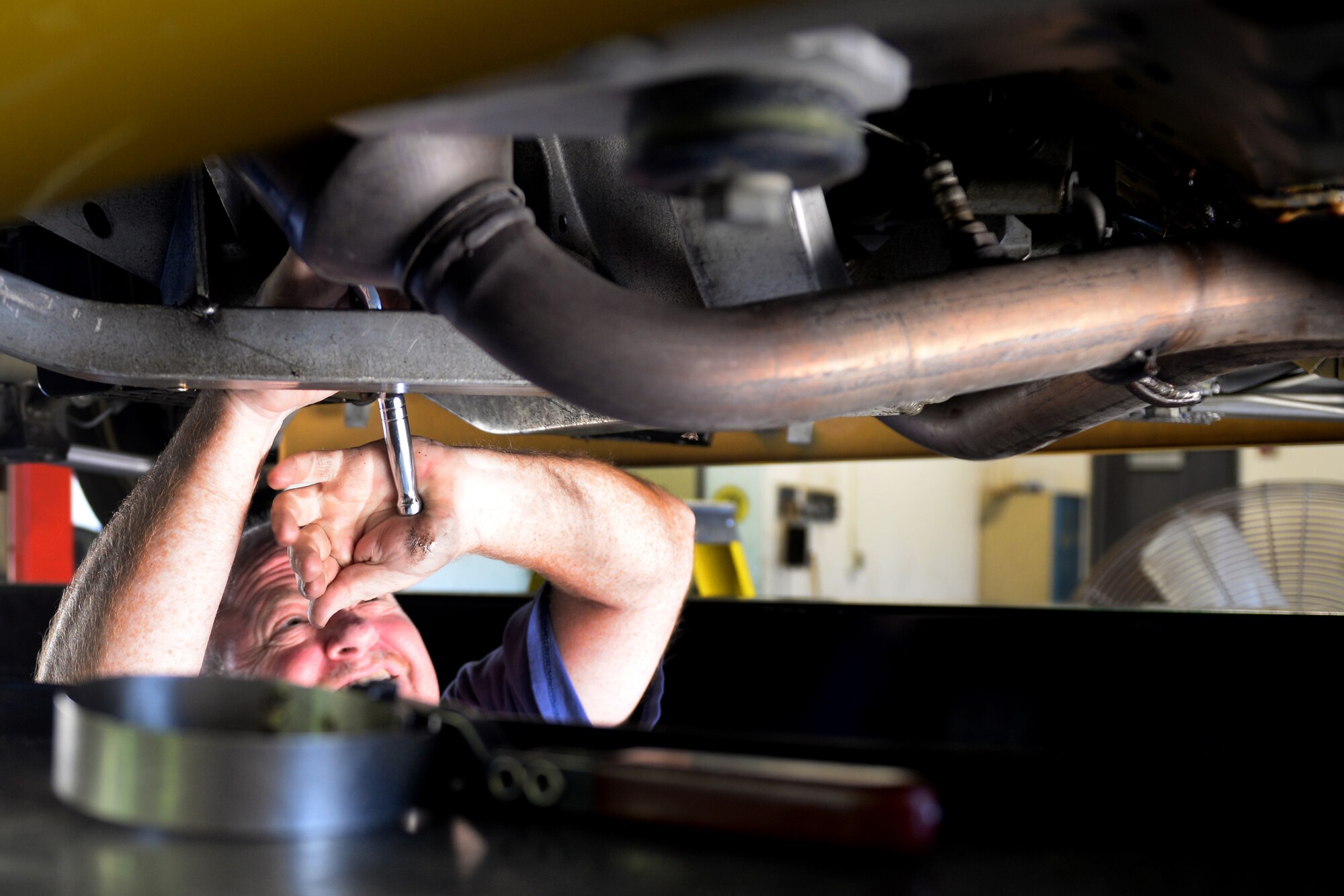 Bart Bosarge, Gaudé Lanes Bowling Center manager, loosens a bolt on the oil pan of his 2002 Chrysler Prowler at the Auto Hobby Shop Feb. 28, 2016, Keesler Air Force Base, Miss. It offers A/C checks, vehicle fluid collection, outdoor and indoor stalls with lifts, dozens of available tools and other services. The Auto Hobby Shop is open to anyone with base access Fridays 12 p.m. – 7 p.m., Saturdays and Sundays 9 a.m. – 4 p.m. (U.S. Air Force photo by Airman 1st Class Travis Beihl)