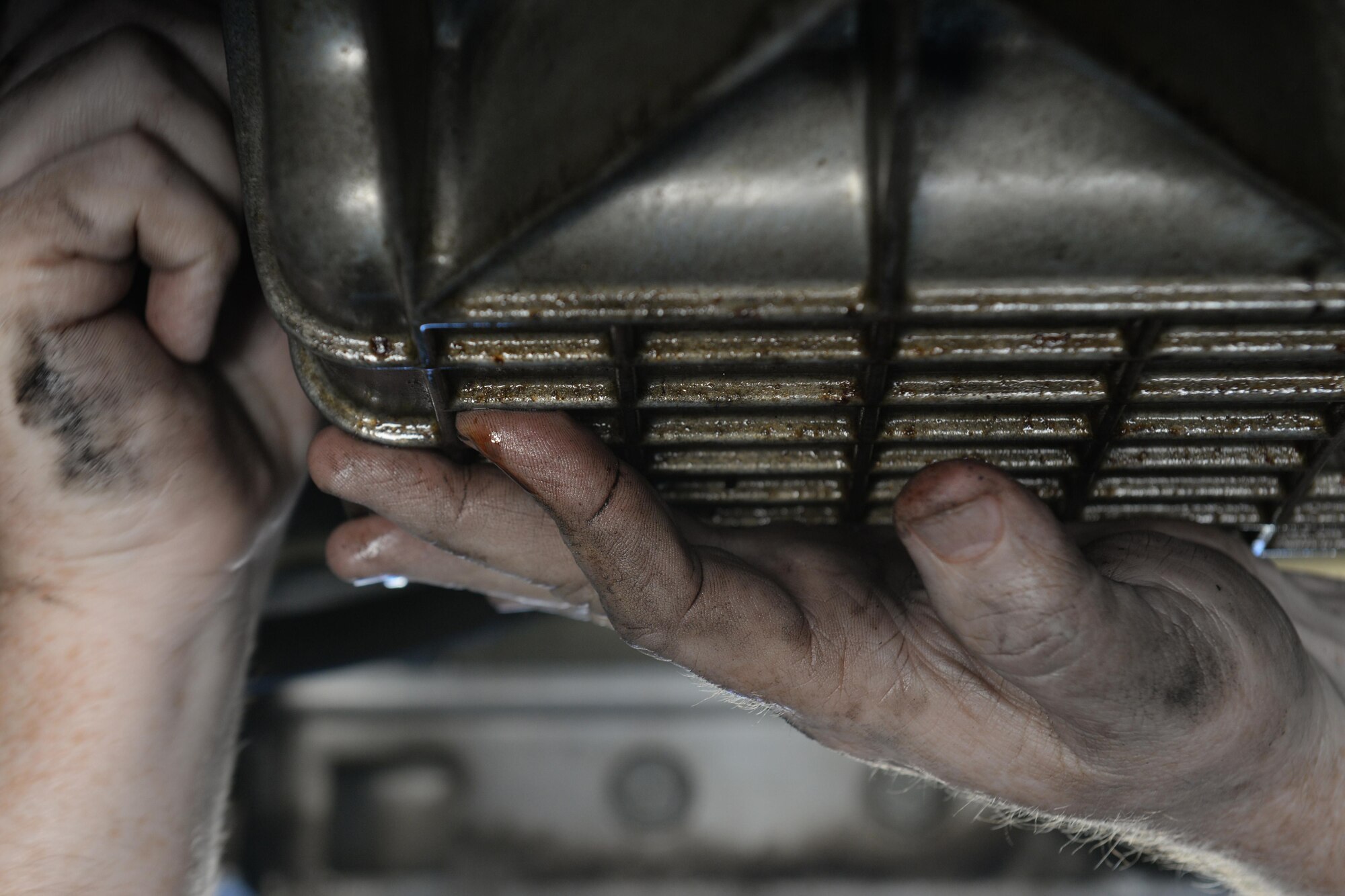 Bart Bosarge, Gaudé Lanes Bowling Center manager, supports the oil pan of his 2002 Chrysler Prowler while loosening a bolt at the Auto Hobby Shop Feb. 28, 2016, Keesler Air Force Base, Miss. It offers A/C checks, vehicle fluid collection, outdoor and indoor stalls with lifts, dozens of available tools and other services. The Auto Hobby Shop is open to anyone with base access Fridays 12 p.m. – 7 p.m., Saturdays and Sundays 9 a.m. – 4 p.m. (U.S. Air Force photo by Airman 1st Class Travis Beihl)