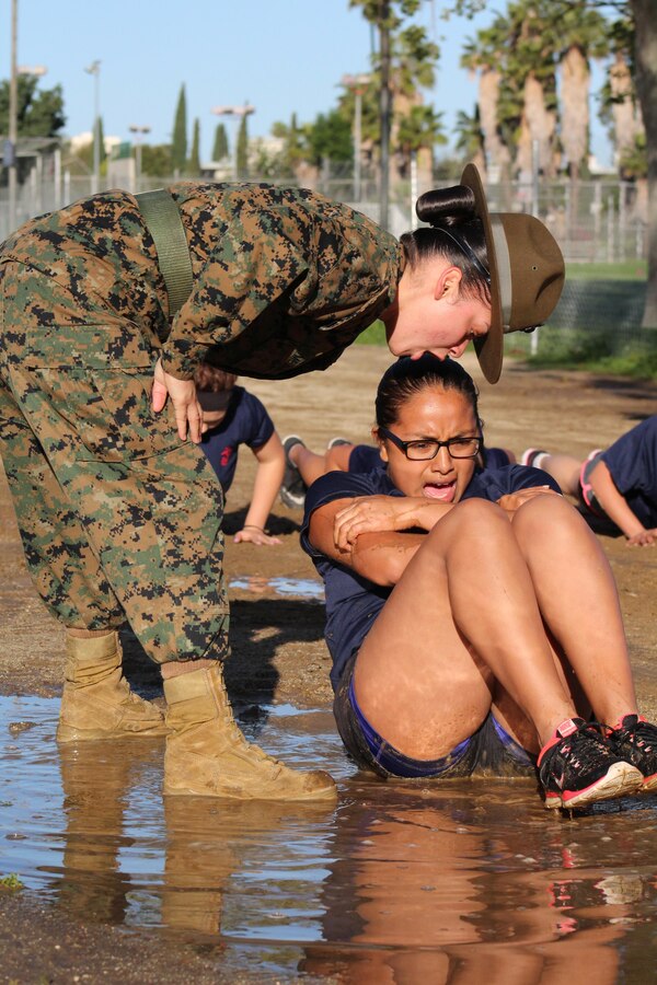 Drill Instructor Staff Sgt. Adrianna Medina commands a poolee from Recruiting Station Orange County to conduct crunches during a female pool function at the Sherman Oaks Recreation Park in Van Nuys, Calif., March 12, 2016. (U.S. Marine Corps photo by Staff Sgt. Alicia R. Leaders/Released)