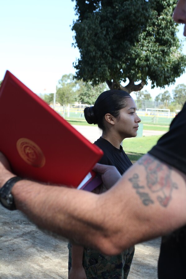 Staff Sgt. Maria E. GarciaRazo prepares to re-enlist in the Marine Corps for four more years in the Marine Corps during a female pool function at the Sherman Oaks Recreation Park in Van Nuys, Calif., March 12, 2016. GarciaRazo is currently the staff noncommissioned officer of Recruiting Sub Station Hollywood of Recruiting Station Los Angeles. (U.S. Marine Corps photo by Staff Sgt. Alicia R. Leaders/Released)