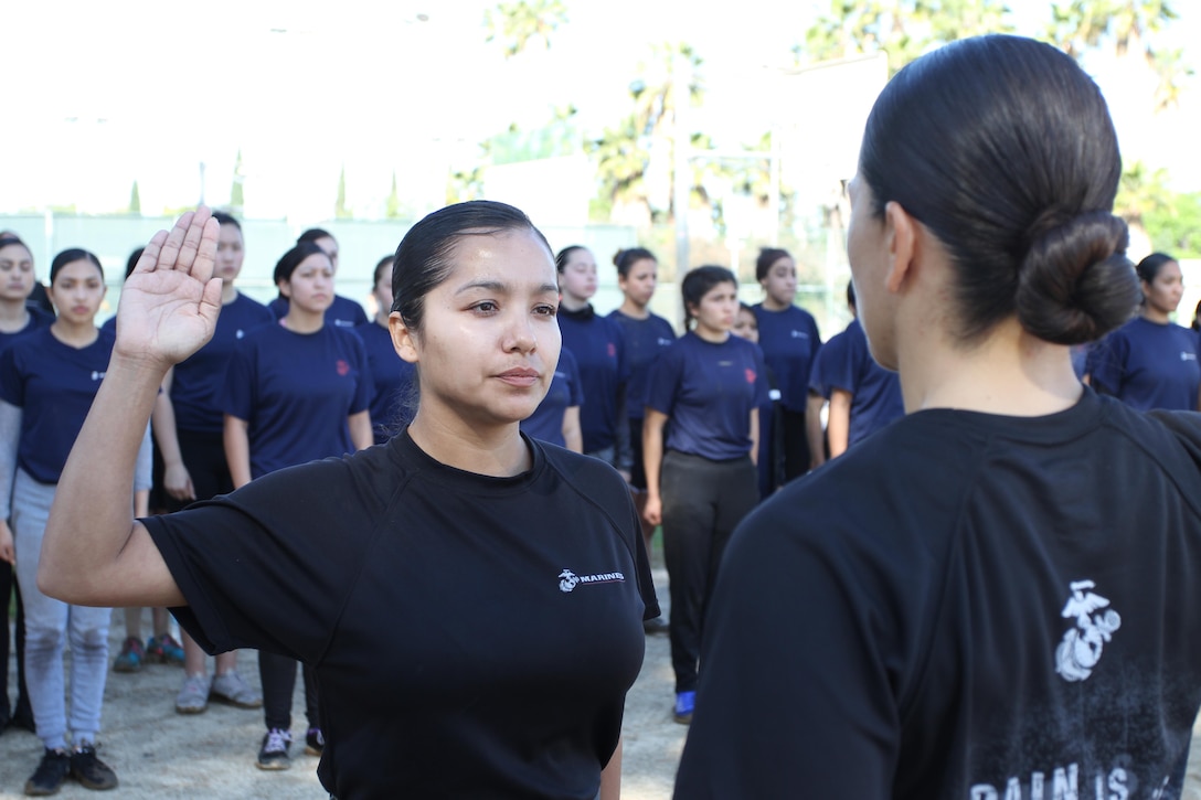 Staff Sgt. Maria E. GarciaRazo re-enlists in the Marine Corps for four more years during a Recruiting Station Los Angeles female pool function at the Sherman Oaks Recreation Park in Van Nuys, Calif., March 12, 2016. GarciaRazo is currently the staff noncommissioned officer of Recruiting Sub Station Hollywood of Recruiting Station Los Angeles. (U.S. Marine Corps photo by Staff Sgt. Alicia R. Leaders/Released)