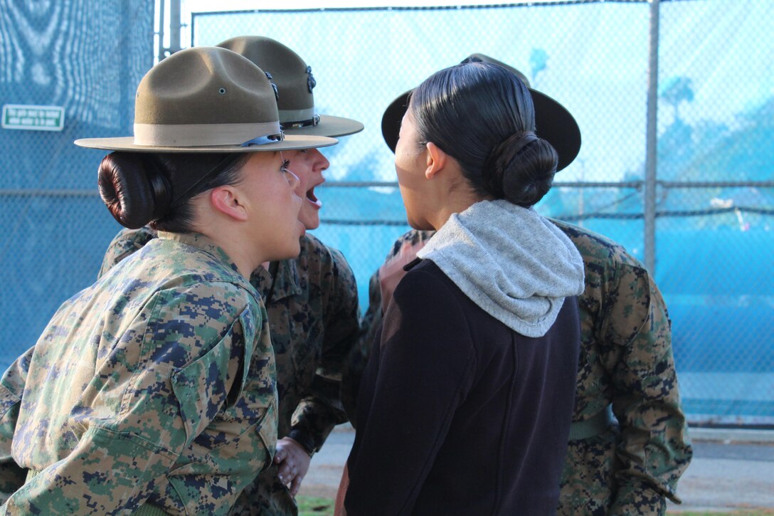 Drill Instructors command Esperanza Zanabria, a poolee from Recruiting Sub Station Downey of Recruiting Station Los Angeles, to get in formation during a female pool function with Recruiting Stations Los Angeles and Orange County at the Sherman Oaks Recreation Park in Van Nuys, Calif., March 12, 2016. (U.S. Marine Corps photo by Staff Sgt. Alicia R. Leaders/Released)
