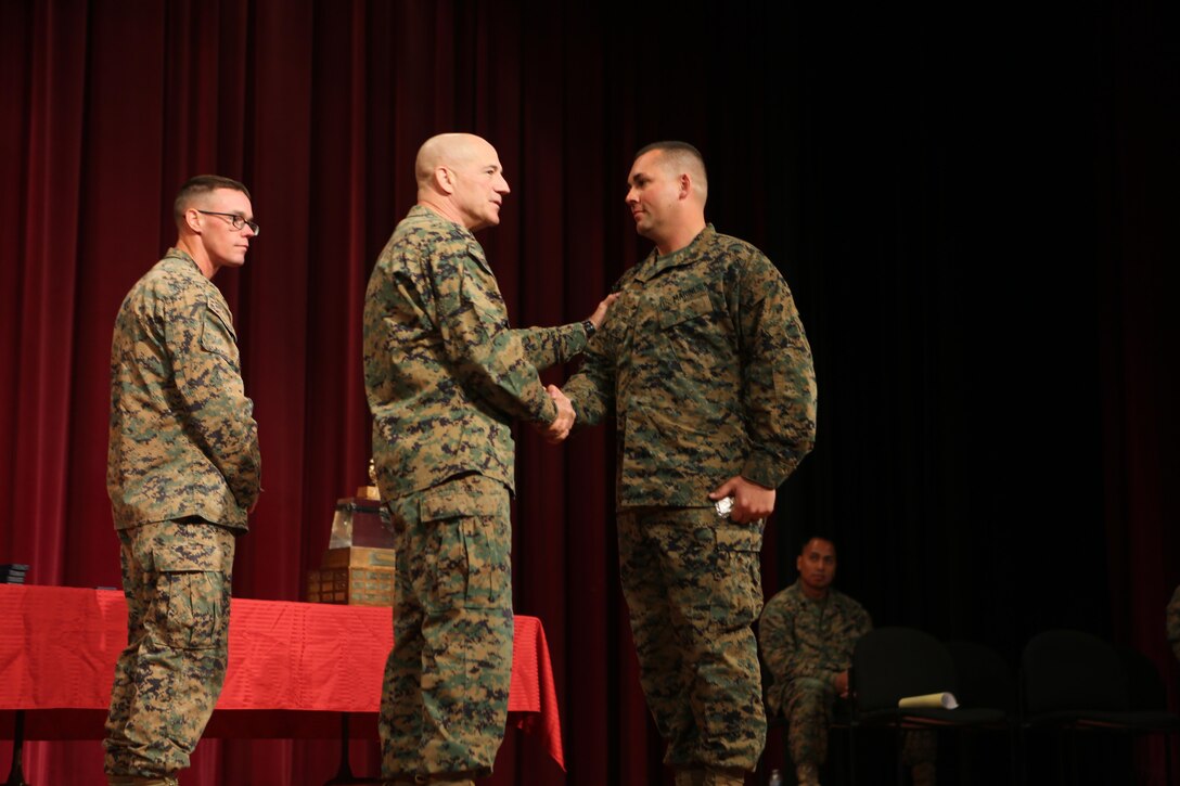 Col. Darric Knight presents Staff Sgt. Justin Santiago with 2nd Battalion, 23rd Marine Regiment, 4th Marine Division, Marine Forces Reserve, a gold medal for the rifle and a bronze medal for the pistol competition during the Western Division Matches aboard Camp Pendleton, Calif., March 4, 2016. The Western Division Matches are part of a Marine Corps wide competition designed for self-improvement in marksmanship in order to improve Marines’ combat readiness. The winners of each regional competition will go to compete in the national match held aboard Camp Lejeune, N.C. 