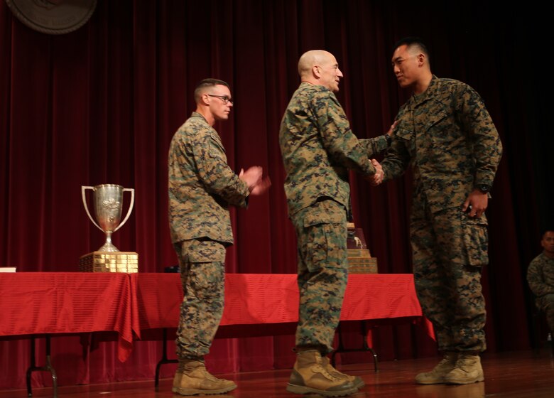 Col. Darric Knight presents Cpl. Alvin Mei, 2nd Battalion, 23rd Marine Regiment, 4th Marine Division, Marine Forces Reserve, the gold medal for the pistol competition during the Western Division Matches aboard Camp Pendleton, Calif., March 4, 2016. The Western Division Matches are part of a Marine Corps wide competition designed for self-improvement in marksmanship in order to improve Marines’ combat readiness. The winners of each regional competition will go to compete in the national match held aboard Camp Lejeune, N.C. 