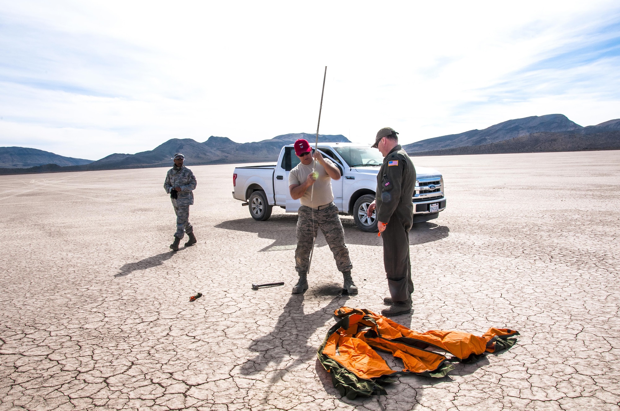 Members from the 94th Airlift Wing set up a marker for a drop zone as they await for supplies dropped from C-130 Hercules during Red Flag 16-2 in the desert near Nellis Air Force Base, Nev., March 5, 2016. Red Flag is an exercise hosted by Nellis Air Force Base, Nev. that provides aircrews an opportunity to experience realistic, stressful combat situations in a controlled environment to increase mission capability. (U.S. Air Force photo/Staff Sgt. Daniel Phelps)
