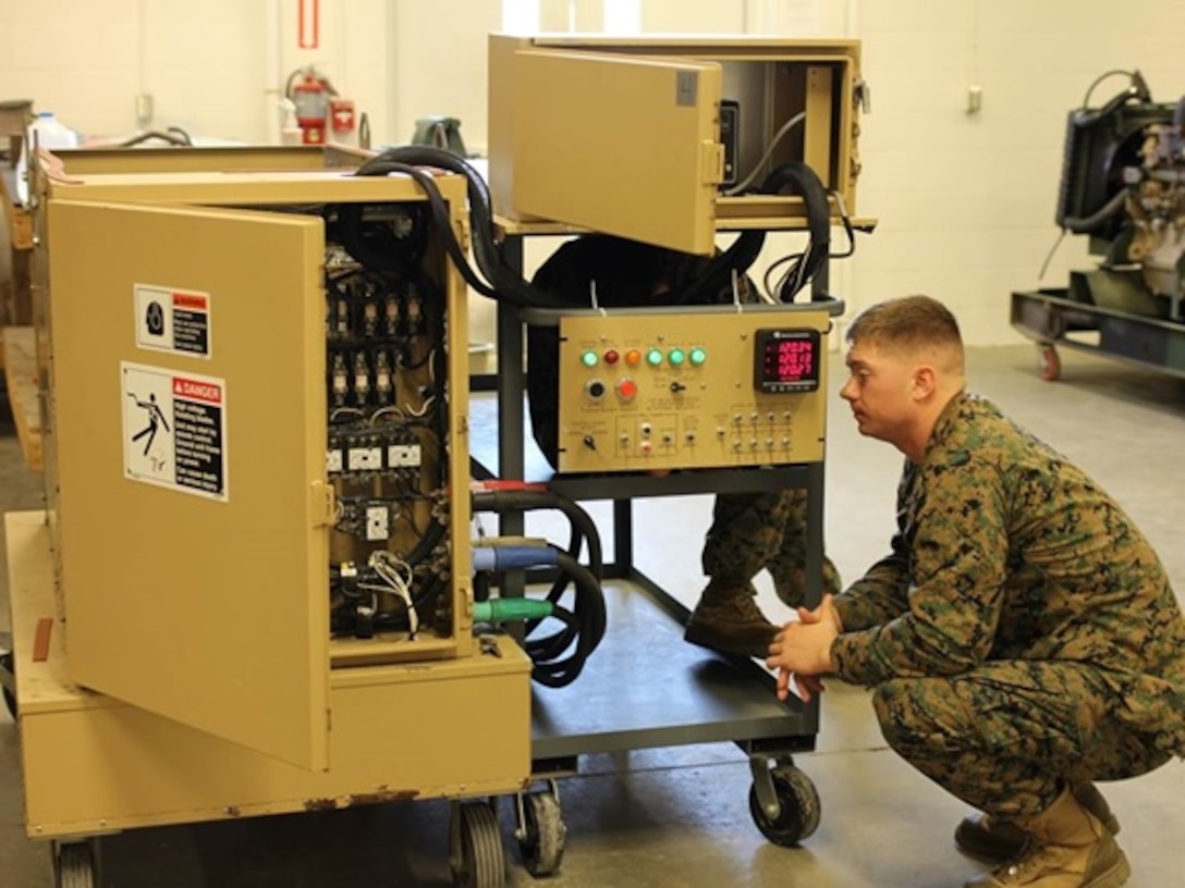 A Marine attending Advanced Engineer Equipment Electrical Systems Technician course 1-16 (AEEEST 1-16) at Marine Corps Engineer School, Camp Lejeune, N.C., enures a load bank is working properly when simulated power consumption is applied during a practical application on a 100 kilowatt load bank.    
