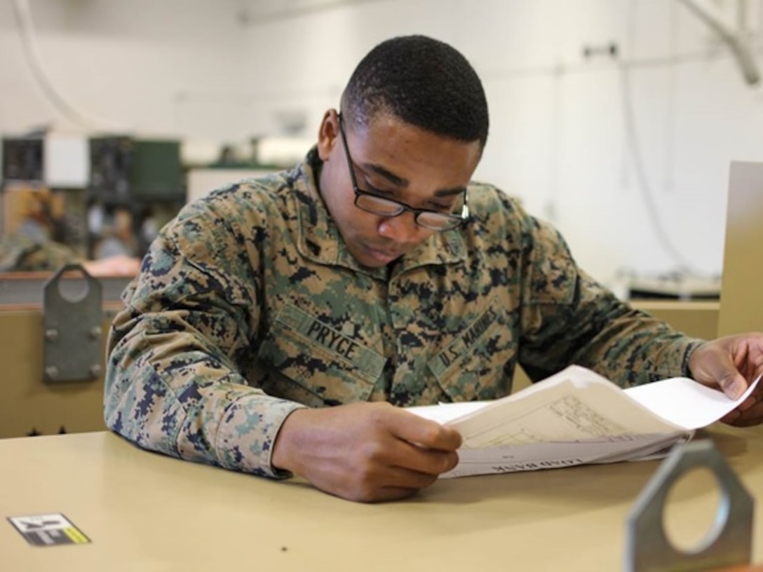 Corporal David S. Pryce, a Marine attending Advanced Engineer Equipment Electrical Systems Technician course 1-16 (AEEEST 1-16) aboard Marine Corps Engineer School, Camp Lejeune, N.C.; reads a schematic for the Load Bank. This part of the practical application teaches the students to use schematic diagrams to understand how the equipment functions, troubleshoot problems that arise, and ultimately find a solution to the problem.   
