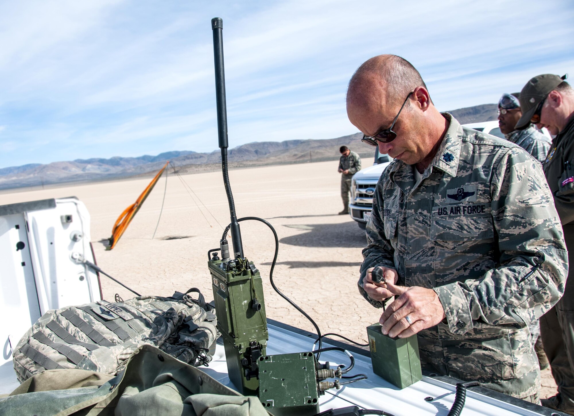Lt. Col. Greg Pelech, 94th Airlift Wing, chief of safety, puts together a radio for communication during an air drop in the desert near Nellis Air Force Base, Nev. during Red Flag 16-2 March 5, 2016. Red Flag 16-2 was an exercise to help joint, allied and coalition partners run through the first 10 days of war. (U.S. Air Force photo/Staff Sgt. Daniel Phelps)
