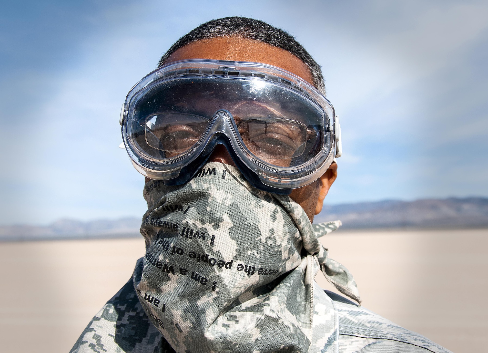 Tech. Sgt. Alvin Lewis, 80th Aerial Port Squadron aerial delivery, prepares for the dust to kick up when C-130 Hercules’ land on a dry lake bed during Red Flag 16-2 near Nellis Air Force Base, Nev., March 5, 2016. Capable of using unprepared runways for takeoffs and landings, the C-130 was originally designed as a troop, medivac and cargo transport aircraft. (U.S. Air Force photo/Staff Sgt. Daniel Phelps)
