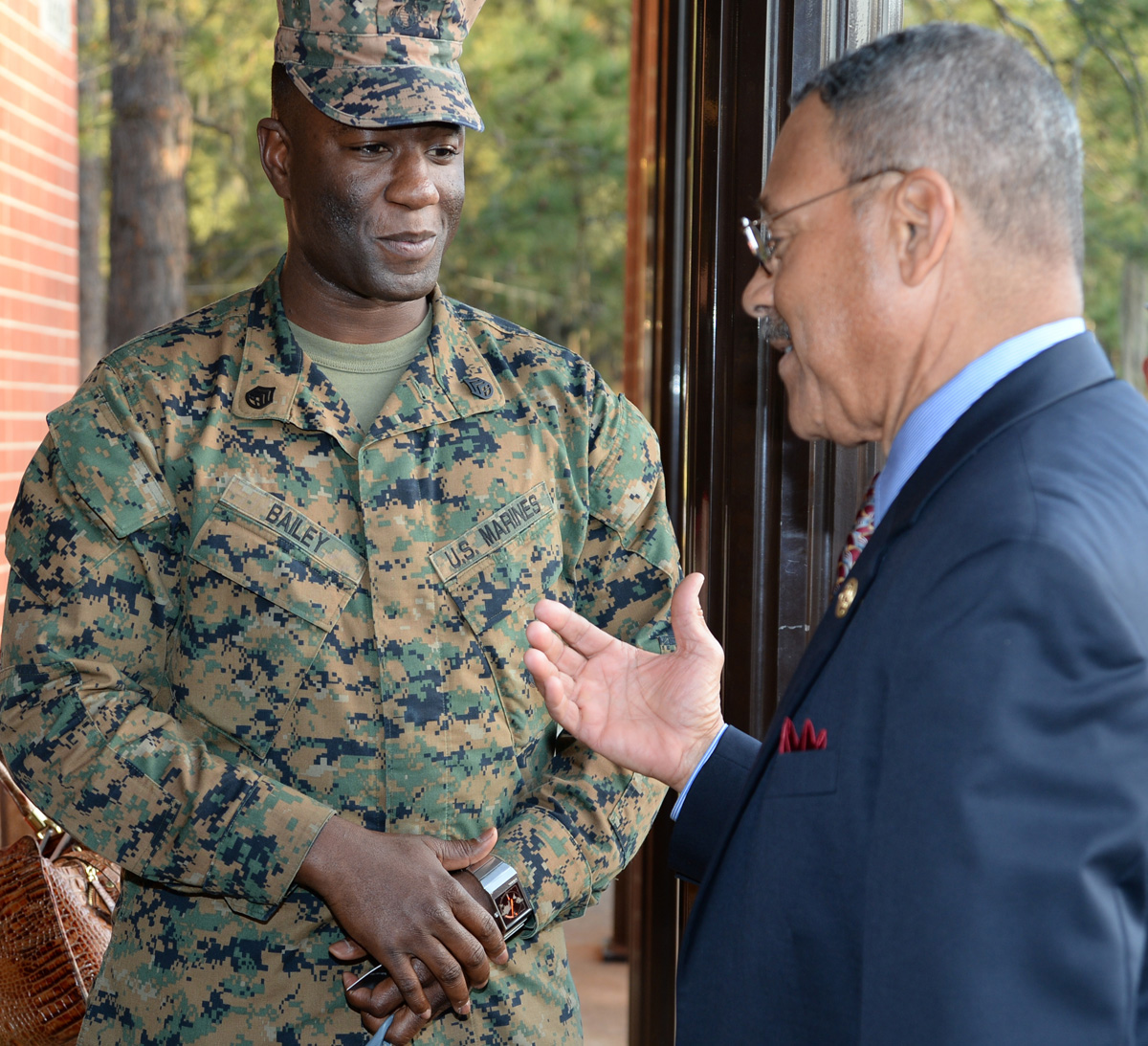 Staff Sgt. Richard Bailey, staff noncommissioned officer-in-charge, Tax Center, MCLB Albany, speaks with U.S. Rep. Sanford D. Bishop, member of Congress, after a town hall meeting held at the Base Theater aboard Marine Corps Logistics Base Albany, March 9.  Bishop serves as co-chair of the Congressional Military Family Caucus and listened to service members as they asked various questions following his remarks about current and past legislation involving pay, health and education benefits, housing and other issues affecting military families.