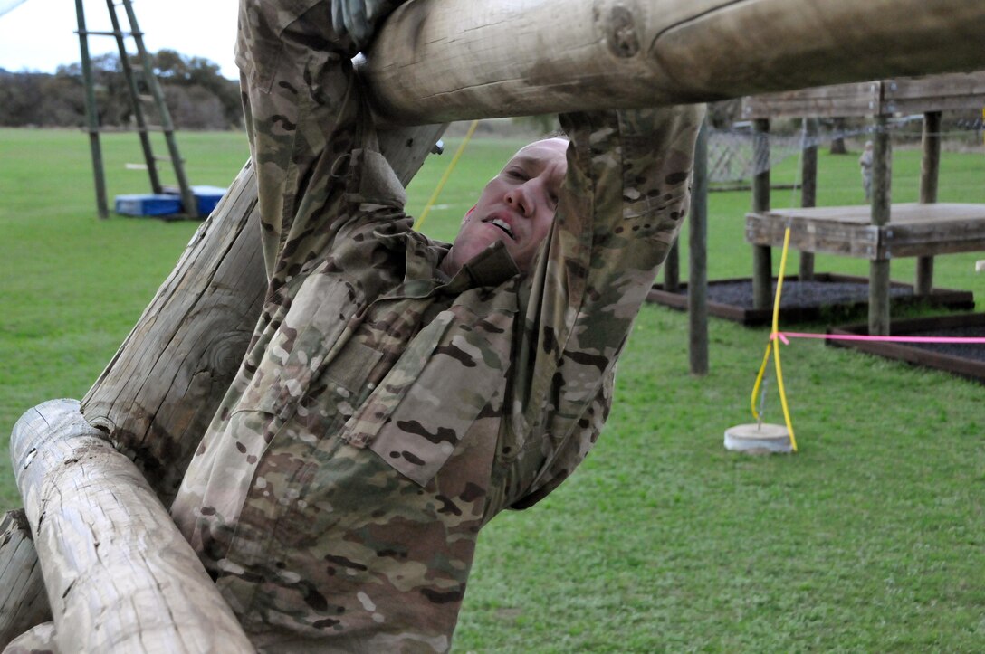 Staff Sgt. Joseph Young, assigned to the U.S. Army Reserve's 319th Army Band at Fort Totten, N.Y., climbs up the "inverted wall" during the obstacle course portion of the 99th Regional Support Command three-day Best Warrior Competition March 10-12 at Camp Bullis, Texas.