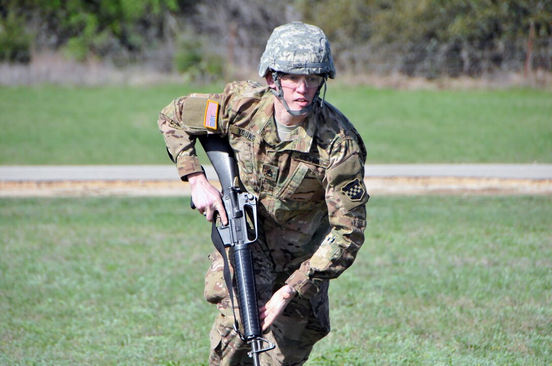 Staff Sgt. Joseph Young, assigned to the U.S. Army Reserve's 319th Army Band at Fort Totten, N.Y., makes his way through a cover and conceal exercise during the 99th Regional Support Command three-day Best Warrior Competition March 10-12 at Camp Bullis, Texas.