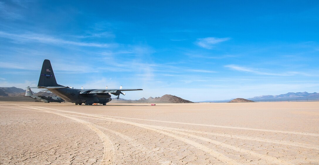 U.S. Air Force C-130 Hercules’ from the 700th Airlift Squadron prepare to take off from a dry lake bed near Nellis Air Force Base, Nev. during Red Flag 16-2 March 5, 2016. The 700th AS is stationed out of Dobbins Air Reserve Base, Ga. Flying units from around the globe deploy to Nellis Air Force Base, Nev. to participate in Red Flag. (U.S. Air Force photo/Staff Sgt. Daniel Phelps)

