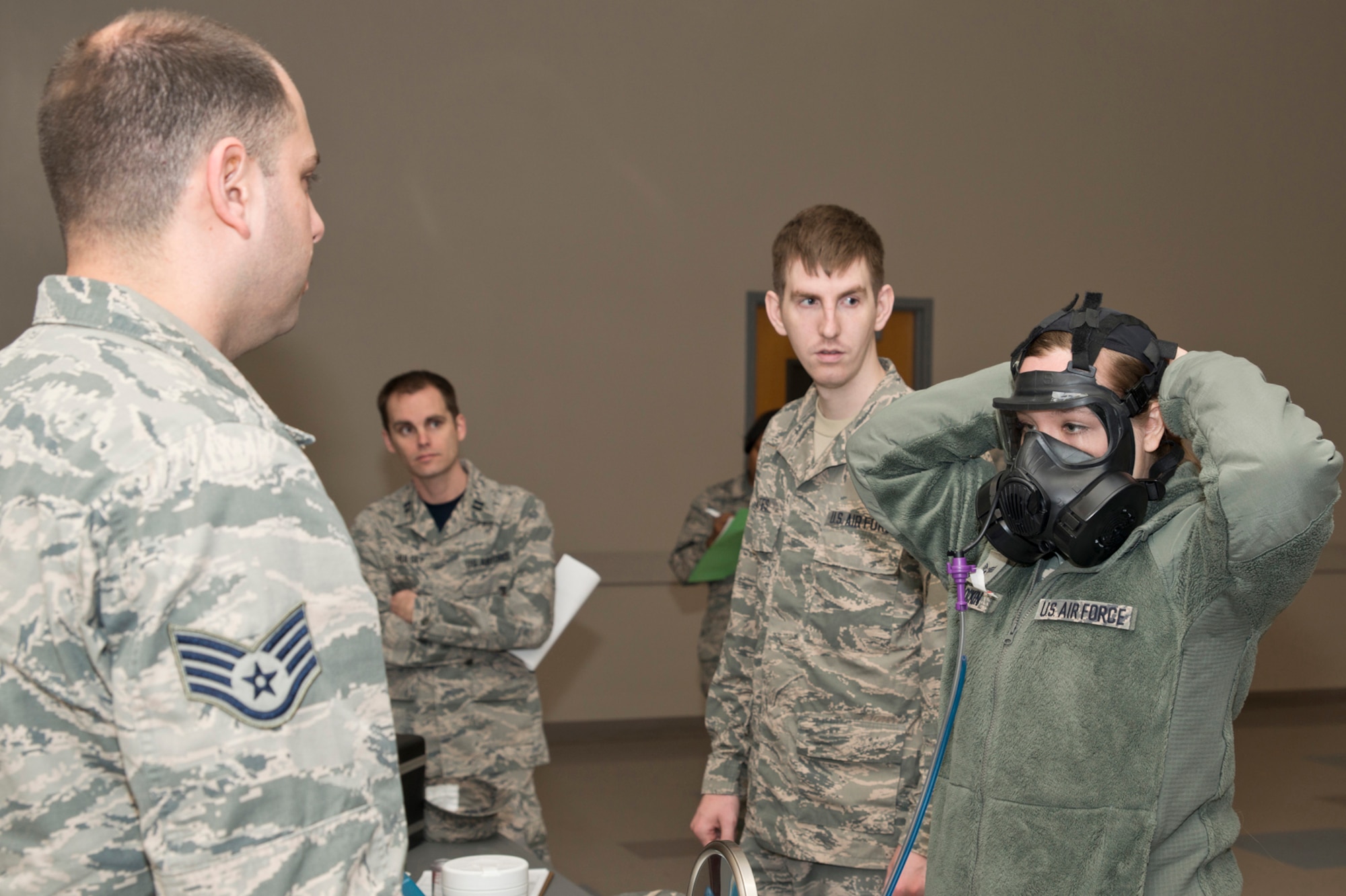 U.S. Air Force Staff Sgt. Kyle Love, 19th Medical Group bioenvironmental technician, conducts a gas mask fit test on Senior Airman Catherine Flocken, at Little Rock Air Force Base, Ark., Mar. 13, 2016. Flocken, who is an air transportation specialist assigned to the 96th Aerial Port Squadron, is completing one of the mandatory requirements for Reservists to be deployment capable.  (U.S. Air Force photo by Master Sgt. Jeff Walston/Released)
