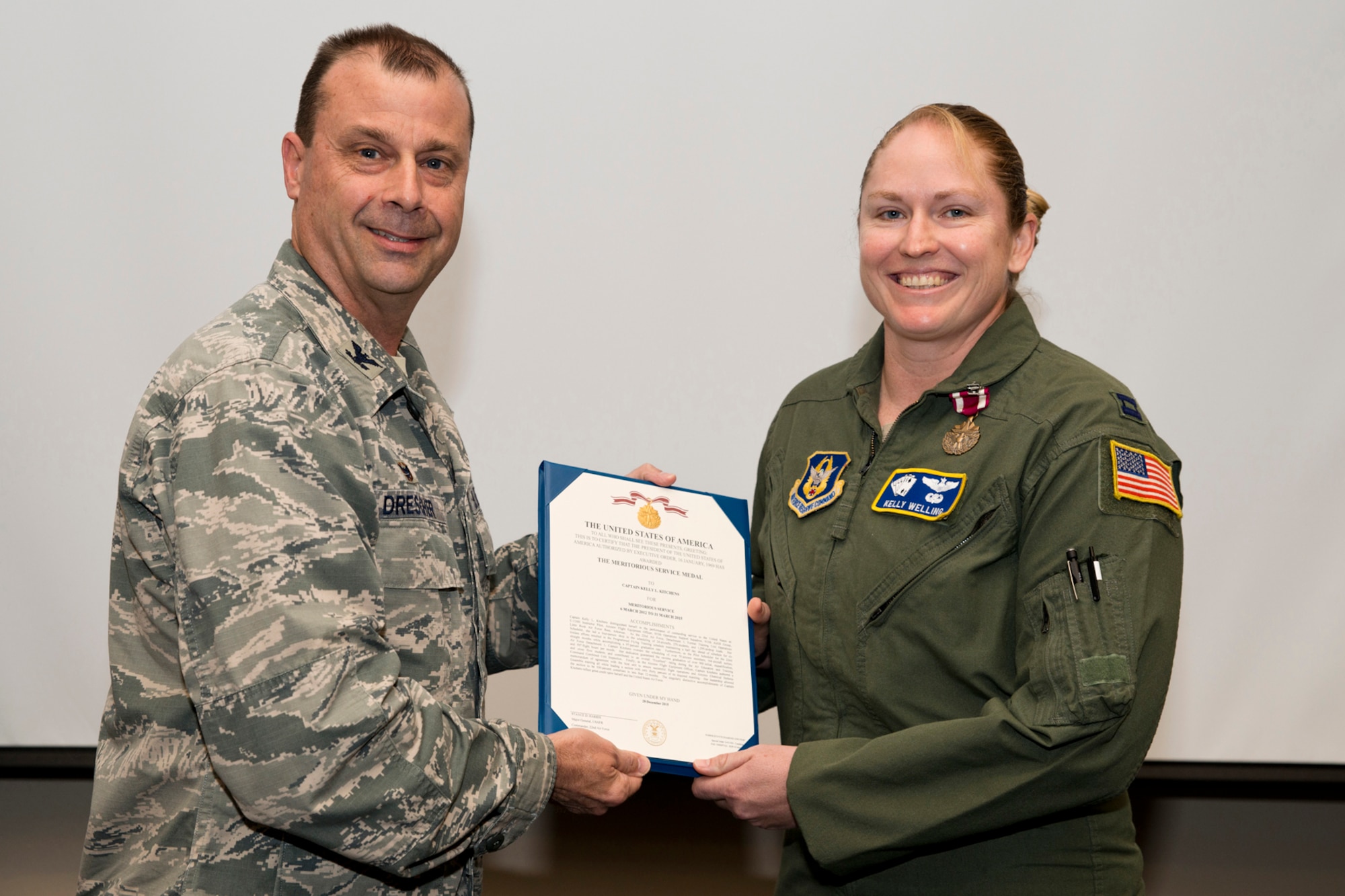 U.S. Air Force Reserve Col. Craig Drescher, commander, 913th Airlift Group, and Capt. Kelly Welling, instructor pilot, 327th Airlift Squadron, pose for a photo during a commander’s call at Little Rock Air Force Base, Ark., Mar. 13, 2016. Welling was awarded the Meritorious Service Medal for outstanding achievement as the C-130H Instructor Pilot and Aircrew Flight Equipment Officer from 6 March 2012 to 31 March 2015. Drescher also recognized 11 additional individuals for personal achievements. (U.S. Air Force photo by Master Sgt. Jeff Walston/Released) 