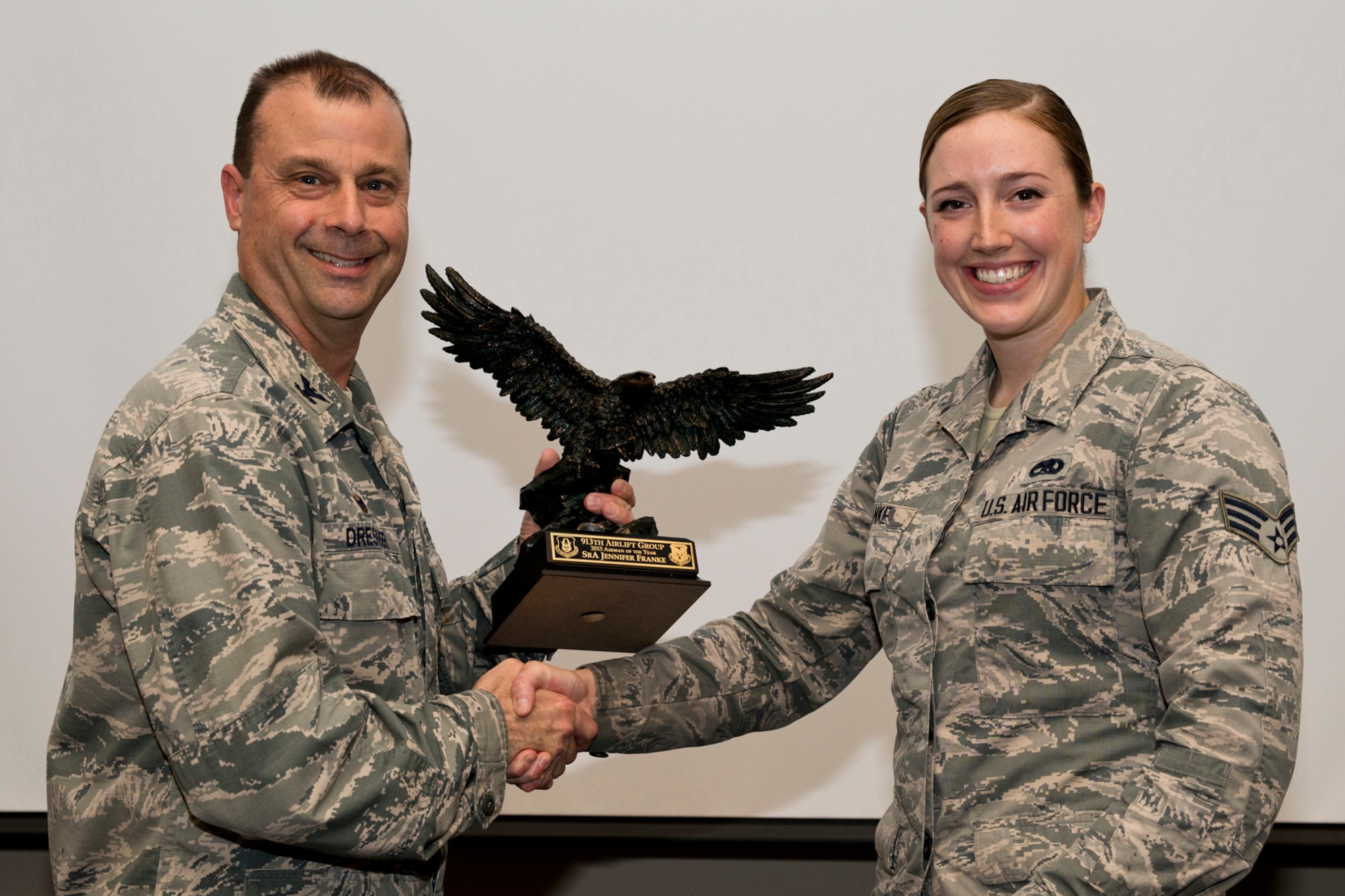 U.S. Air Force Reserve Col. Craig Drescher, commander, 913th Airlift Group, and Senior Airman Jennifer Franke, a crew chief assigned to the 913th Maintenance Squadron, pose for a photo during a commander’s call at Little Rock Air Force Base, Ark., Mar. 13, 2016. Franke was presented the 2015 Airman of the Year award for the 913 AG. (U.S. Air Force photo by Master Sgt. Jeff Walston/Released)