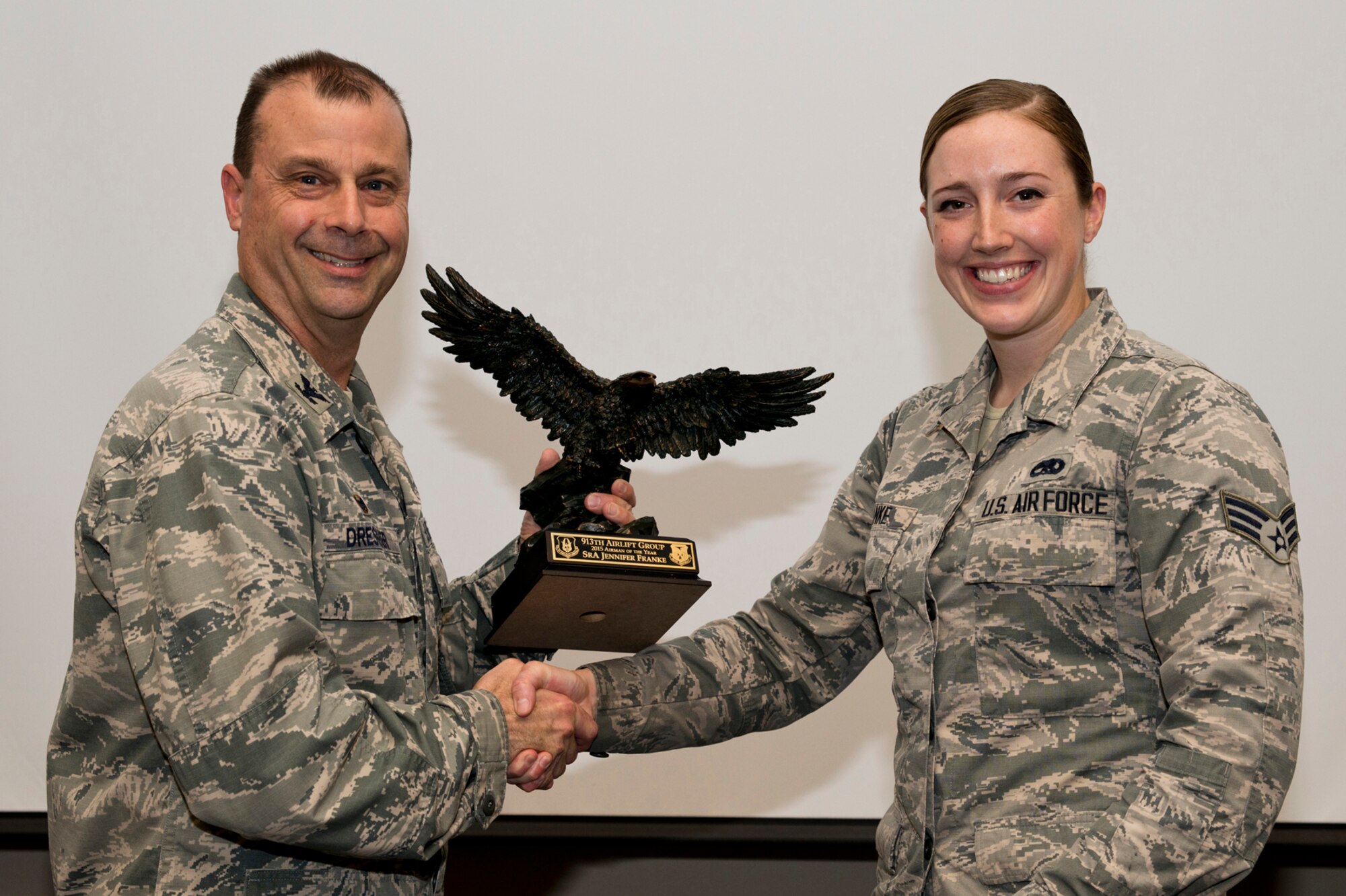 U.S. Air Force Reserve Col. Craig Drescher, commander, 913th Airlift Group, and Senior Airman Jennifer Franke, a crew chief assigned to the 913th Maintenance Squadron, pose for a photo during a commander’s call at Little Rock Air Force Base, Ark., Mar. 13, 2016. Franke was presented the 2015 Airman of the Year award for the 913 AG. (U.S. Air Force photo by Master Sgt. Jeff Walston/Released)