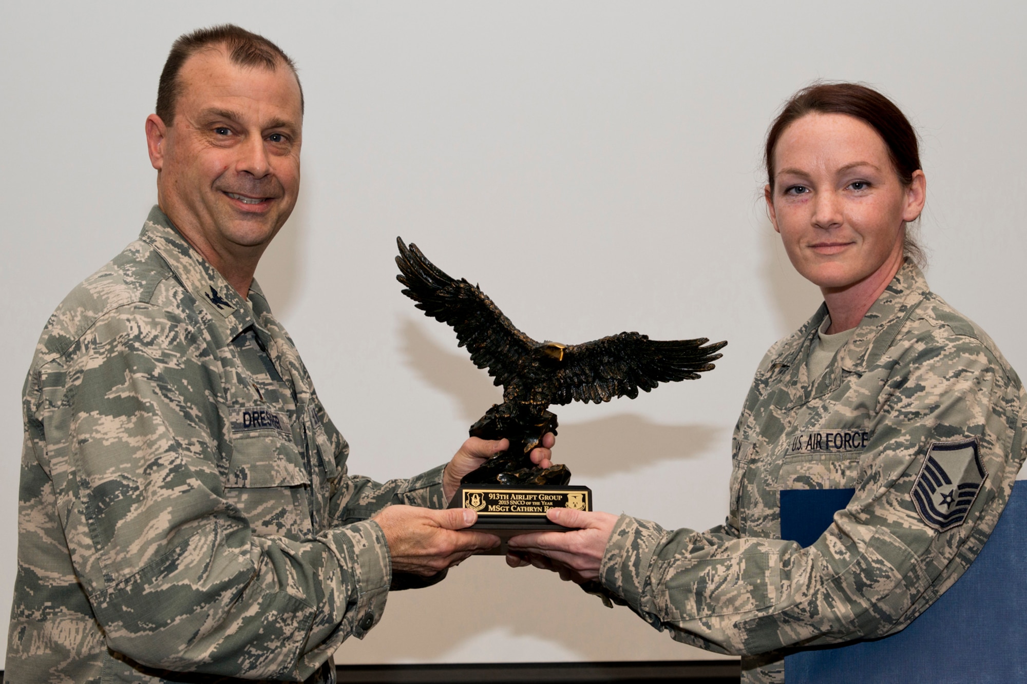 U.S. Air Force Reserve Col. Craig Drescher, commander, 913th Airlift Group, and Master Sgt. Cathryn Rock, a dedicated crew chief assigned to the 913th Maintenance Squadron, pose for a photo during a commander’s call at Little Rock Air Force Base, Ark., Mar. 13, 2016. Rock was presented the 2015 Senior Non-commissioned Officer of the Year award for the 913 AG. (U.S. Air Force photo by Master Sgt. Jeff Walston/Released)