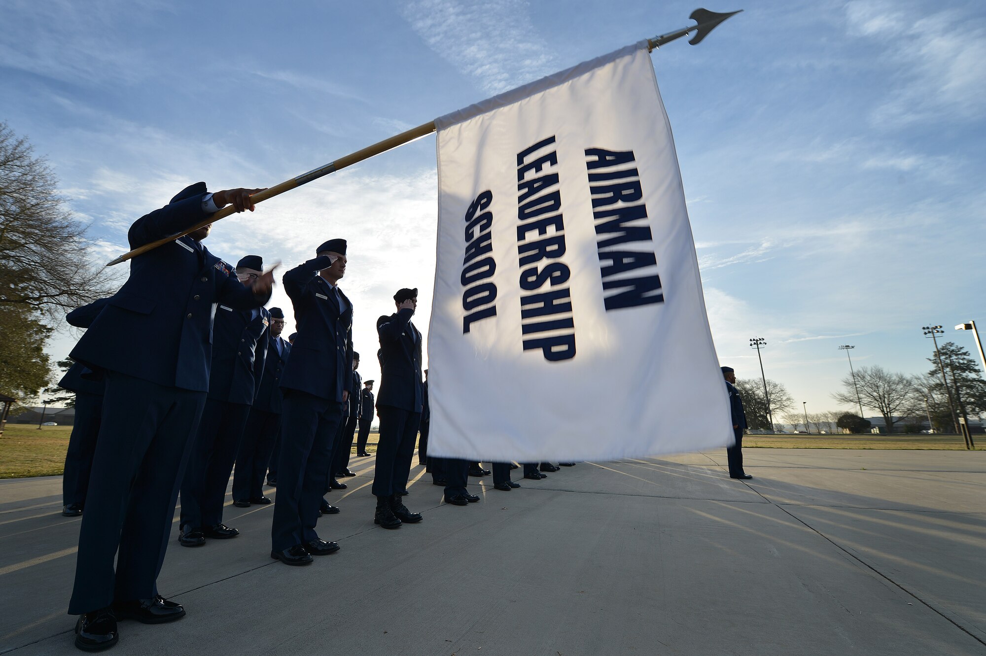 U.S. Airmen assigned to the Senior Master Sgt. David B. Reid Airman Leadership School Class 16-03 salute the flag during reveille at Shaw Air Force Base, S.C., March 10, 2016. During ALS, Airmen learn supervisory communication skills, professional Airmen knowledge, and expeditionary Airmen tactics. (U.S. Air Force photo by Senior Airman Michael Cossaboom)