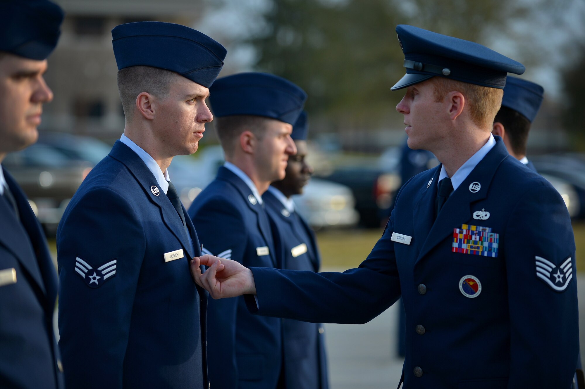 U.S. Air Force Staff Sgt. Jesse Santini, 20th Force Support Squadron Senior Master Sgt. David B. Reid Airman Leadership School instructor, identifies discrepancies on a uniform during a uniform inspection of one of his students in ALS Class 16-03 at Shaw Air Force Base, S.C., March 10, 2016. During a uniform inspection, instructors check all ribbons, stripes, and accouterments to ensure the Airmen are meeting all standards listed in Air Force Instruction 36-2903 Dress and Appearance. (U.S. Air Force photo by Senior Airman Michael Cossaboom) 