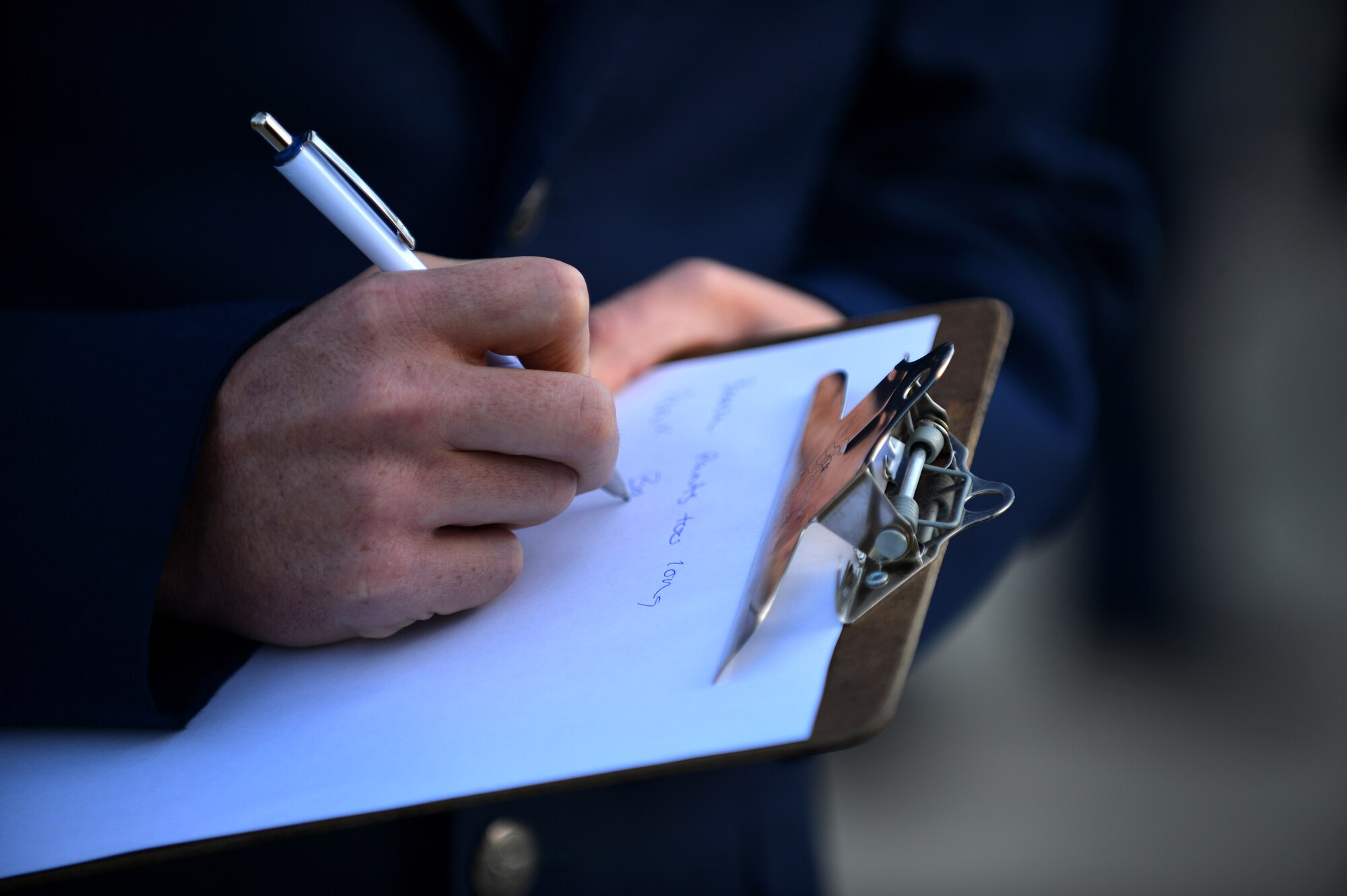A U.S. Airman assigned to the Senior Master Sgt. David B. Reid Airman Leadership School Class 16-03 takes notes after a uniform inspection at Shaw Air Force Base, S.C., March 10, 2016. Instructors check ribbons, ranks, and accouterments to ensure Airmen are meeting all standards listed in Air Force Instruction 36-2903 Dress and Appearance. (U.S. Air Force photo by Senior Airman Michael Cossaboom) 