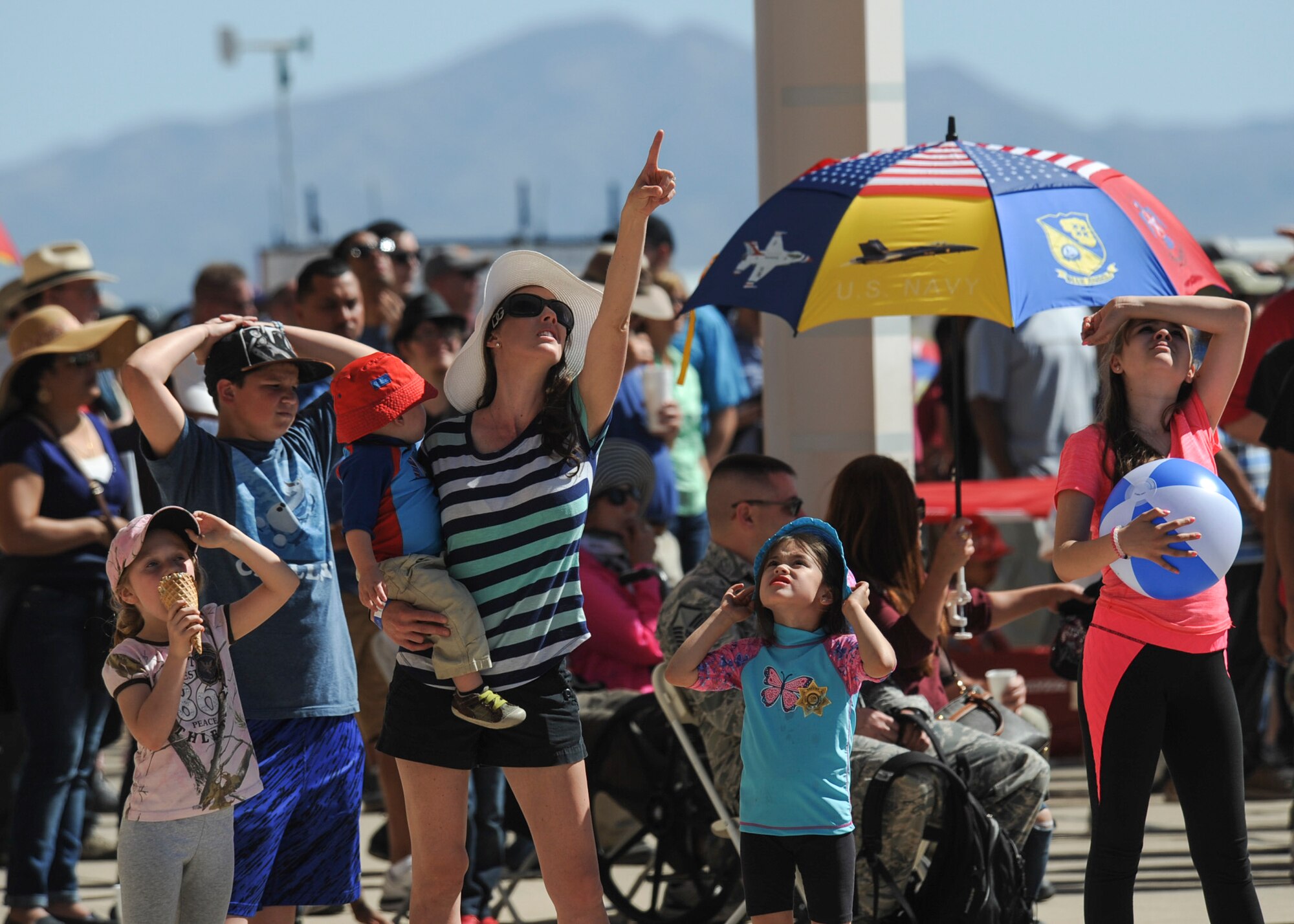 Thunder and Lightning over Arizona Open House patrons look to the sky during an aerial demonstration at Davis-Monthan Air Force Base, Ariz., March 13, 2016. The Open House gave the local community a chance to enter D-M AFB and witness various ground and aerial demonstrations that showcase military air power. (U.S. Air Force photo by Airman Nathan H. Barbour/Released)
