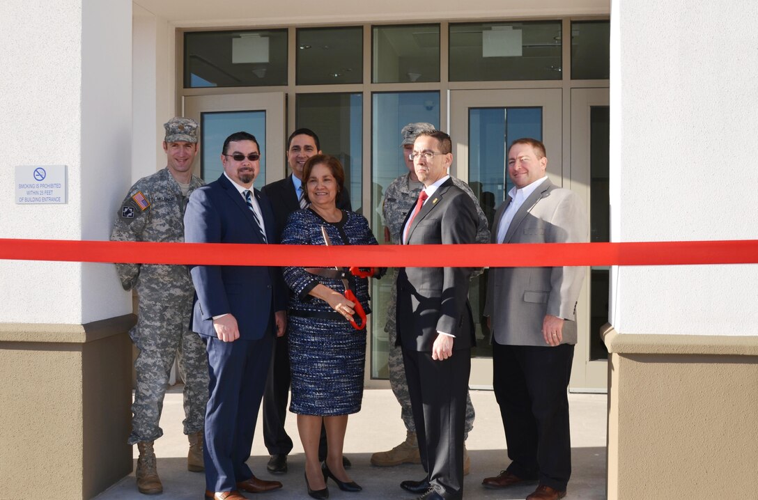 EL PASO, Texas -- Deputy District Commander Maj. Jason Melchior (left) participated in a ribbon-cutting ceremony with officials from Immigration and Customs Enforcement (ICE), Fort Bliss and the contractor to officially open a new 80,000 square-foot facility for ICE on Fort Bliss property here, Feb. 24, 2016. ICE Director Sarah Saldaña (center) prepares to cut the ribbon.