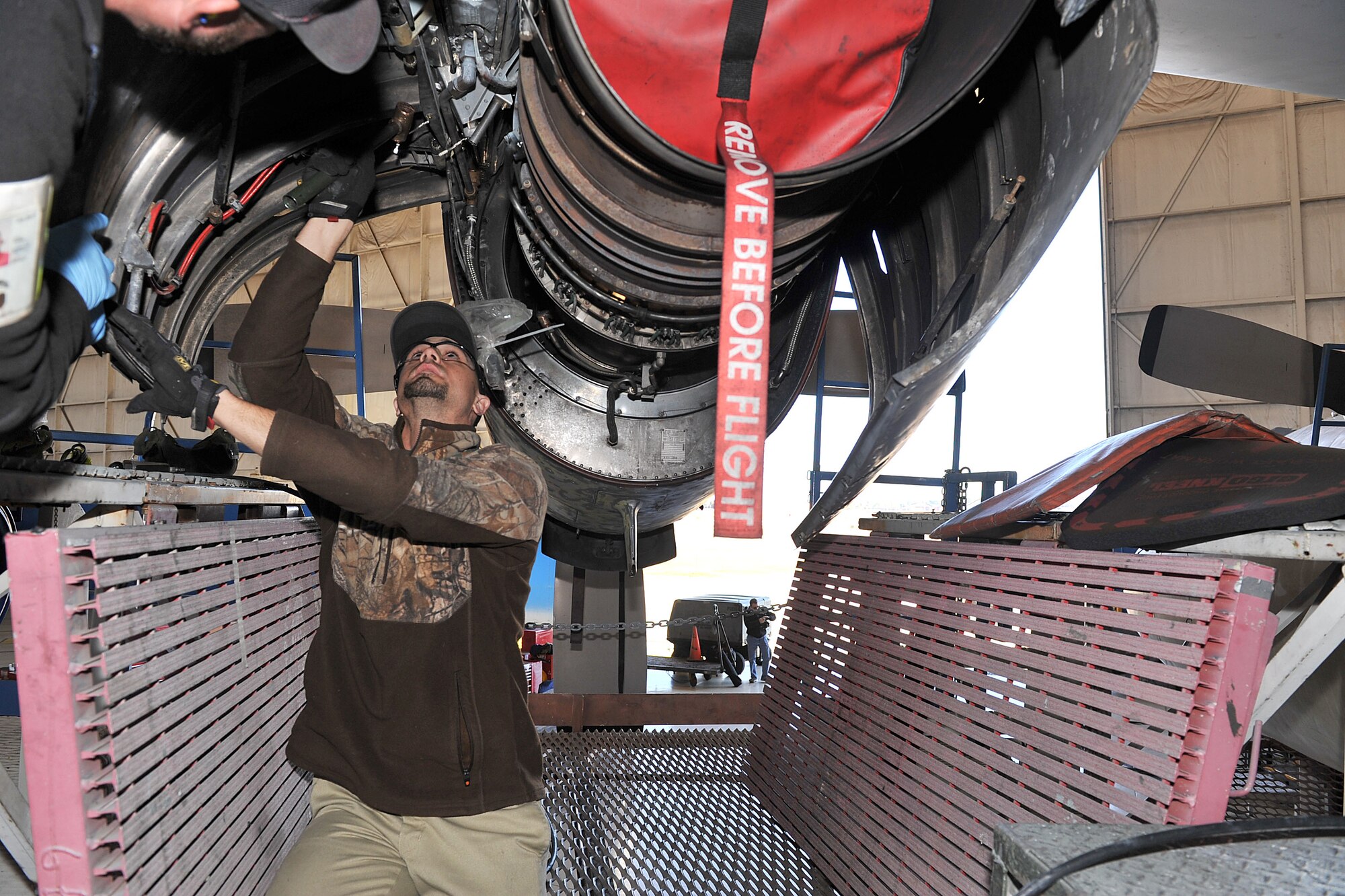 Philip Blackwell, 560th Aircraft Maintenance Squadron sheet metal mechanic, attaches an Air Force Special Operations Command MC-130H’s clam shell door with the assistance of fellow mechanic, Brian Tindall. (U.S. Air Force photo by Tommie Horton) 
