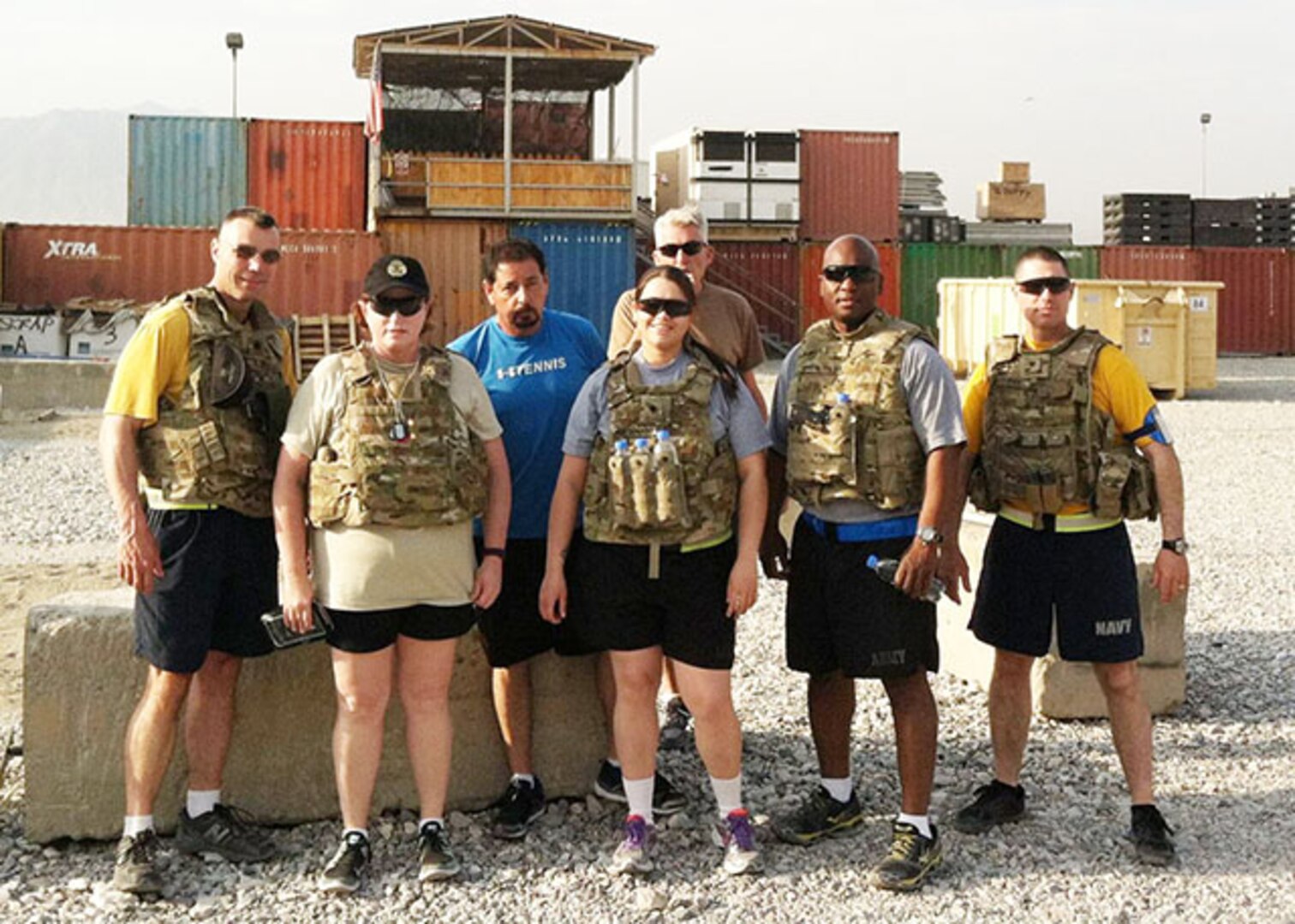 Defense Logistics Agency Aviation Director of Business Process Support, Teresa Smith, first row, second from the left, stands with team members as they prepare for a 10-mile Ruck March on July 28, 2015 at Bagram Airfield, Afghanistan. Smith used the physical resiliency building block to help cope with the stress when she deployed in 2015 as the DLA Support Team Afghanistan deputy commander. 