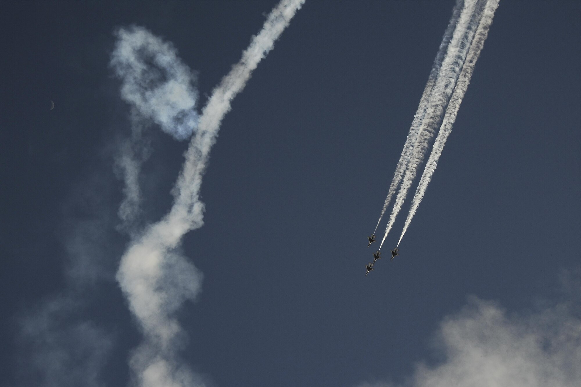 The U.S. Air Force Air Demonstration Squadron, the Thunderbirds, performs an "Arrowhead Loop" during the Thunder and Lightning over Arizona Open House at Davis-Monthan Air Force Base, Ariz., March 13, 2016. The aerial demonstrations exhibited some of the maximum capabilities of the F-16 Fighting Falcon, the Air Force’s premier multi-role fighter jet. For each Thunderbirds F-16 aircraft that travels, a crew chief and an assistant crew chief are assigned to it, ensuring their jet is always mission-ready. (U.S. Air Force photo by Airman 1st Class Mya M. Crosby/Released)
