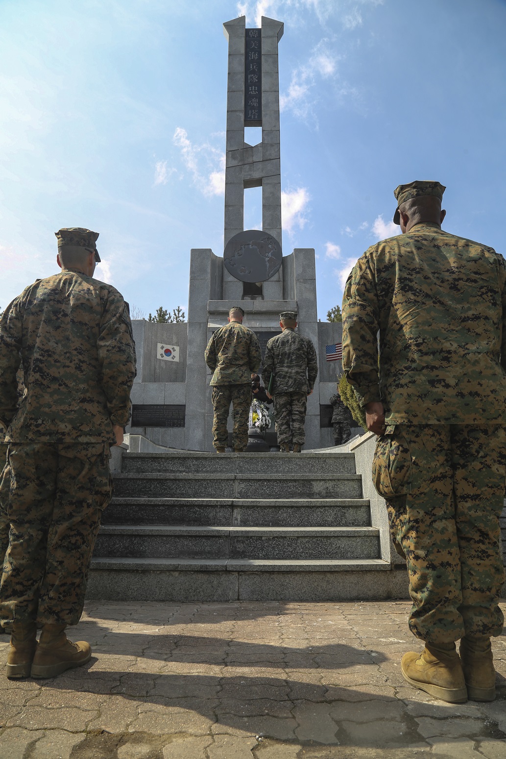 U.S. Marines and Sailors with the Boxer Amphibious Ready Group and 13th Marine Expeditionary Unit participate in a ceremony with Marines from the Republic of Korea, March 10, 2016, commemorating the ultimate sacrifice of service members from both countries as Exercise Ssang Yong 16 in Pohang, South Korea continues. Ssang Yong is a biennial military exercise focused on strengthening the amphibious landing capabilities of the Republic of Korea, the U.S., New Zealand and Australia. (U.S. Marine Corps photo by Sgt. Briauna Birl/RELEASED)