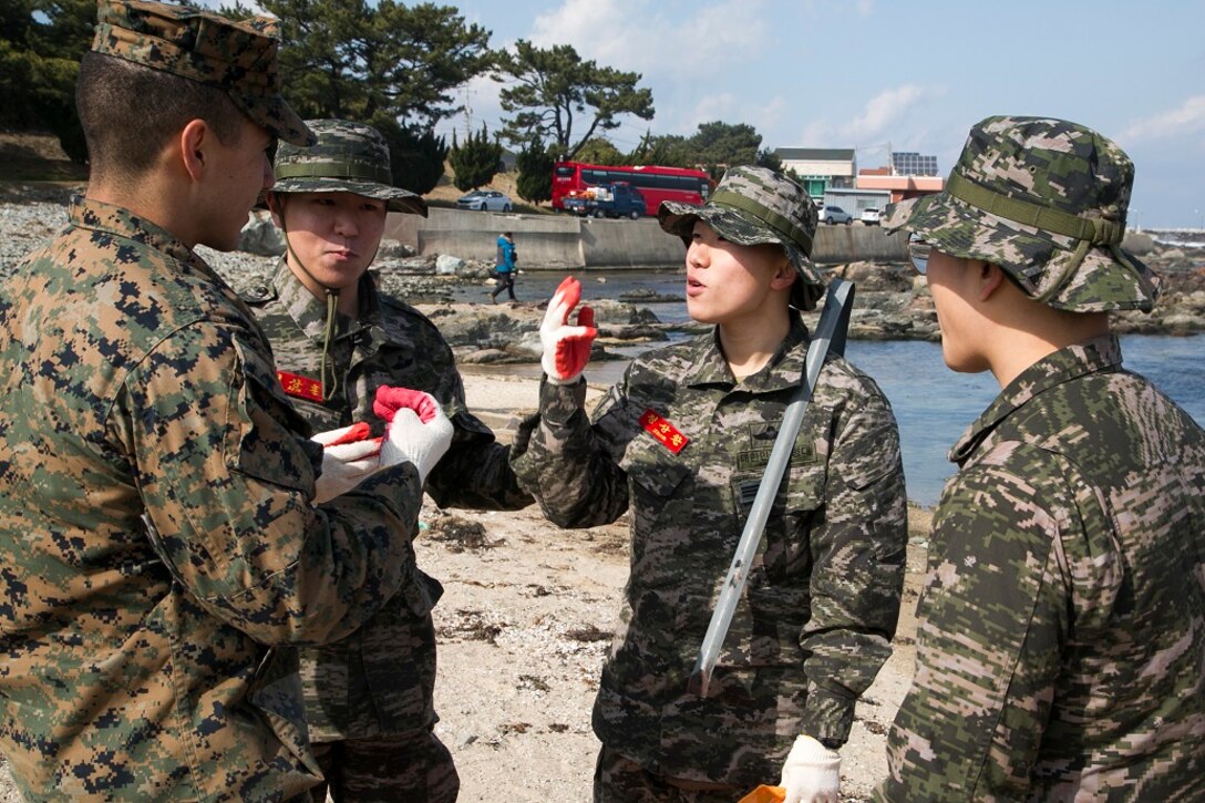 U.S. Marines and Sailors with the Boxer Amphibious Ready Group and 13th Marine Expeditionary Unit (MEU), overcome language barriers with Marines from the Republic of Korea, March 10, 2016, to clean a local beach in a combined effort to spread good community relations during Exercise Ssang Yong in Pohang, South Korea.  Ssang Yong is a biennial military exercise focused on strengthening the amphibious landing capabilities of the Republic of Korea, the U.S., New Zealand and Australia. (U.S. Marine Corps photo by Sgt. Briauna Birl/RELEASED)