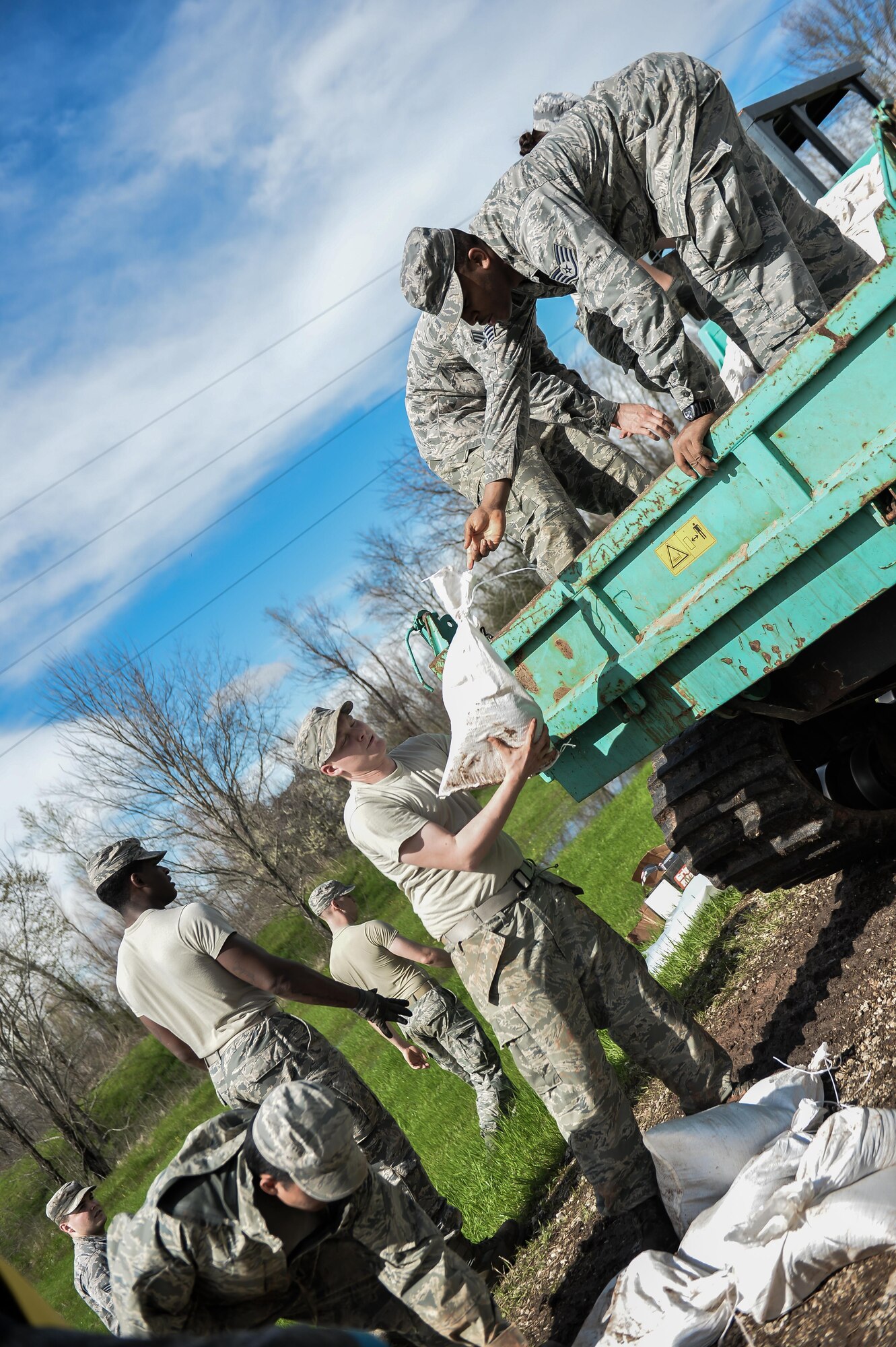 Barksdale Airmen unload sandbags in Bossier City, La., March 10, 2016. The additional manpower decreased the time needed to create the defensive barriers, reducing the changes of damage to the Red Chute Bayou levee.  (U.S. Air Force photo/Senior Airman Mozer O. Da Cunha)