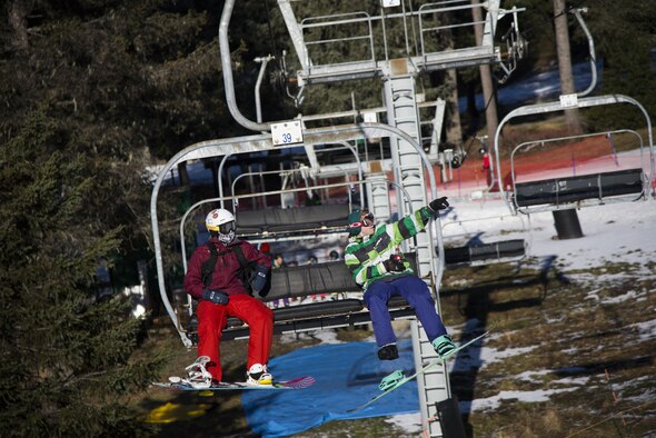 U.S. Air Force Airman 1st Class Kyle Kennedy, a  354th Logistics Readiness Squadron journeyman (left) and Senior Airman Alex Westing, a 354th Comptroller Squadron journeyman (right) ride a ski lift at Aleyska Resort in Girdwood, Alaska, March 3, 2016. The chapel sponsored a ski trip to Aleyska Resort for 16 unaccompanied Airman to bond and help build morale. (U.S. Air Force photo by Senior Airman Joshua Weaver/Released)