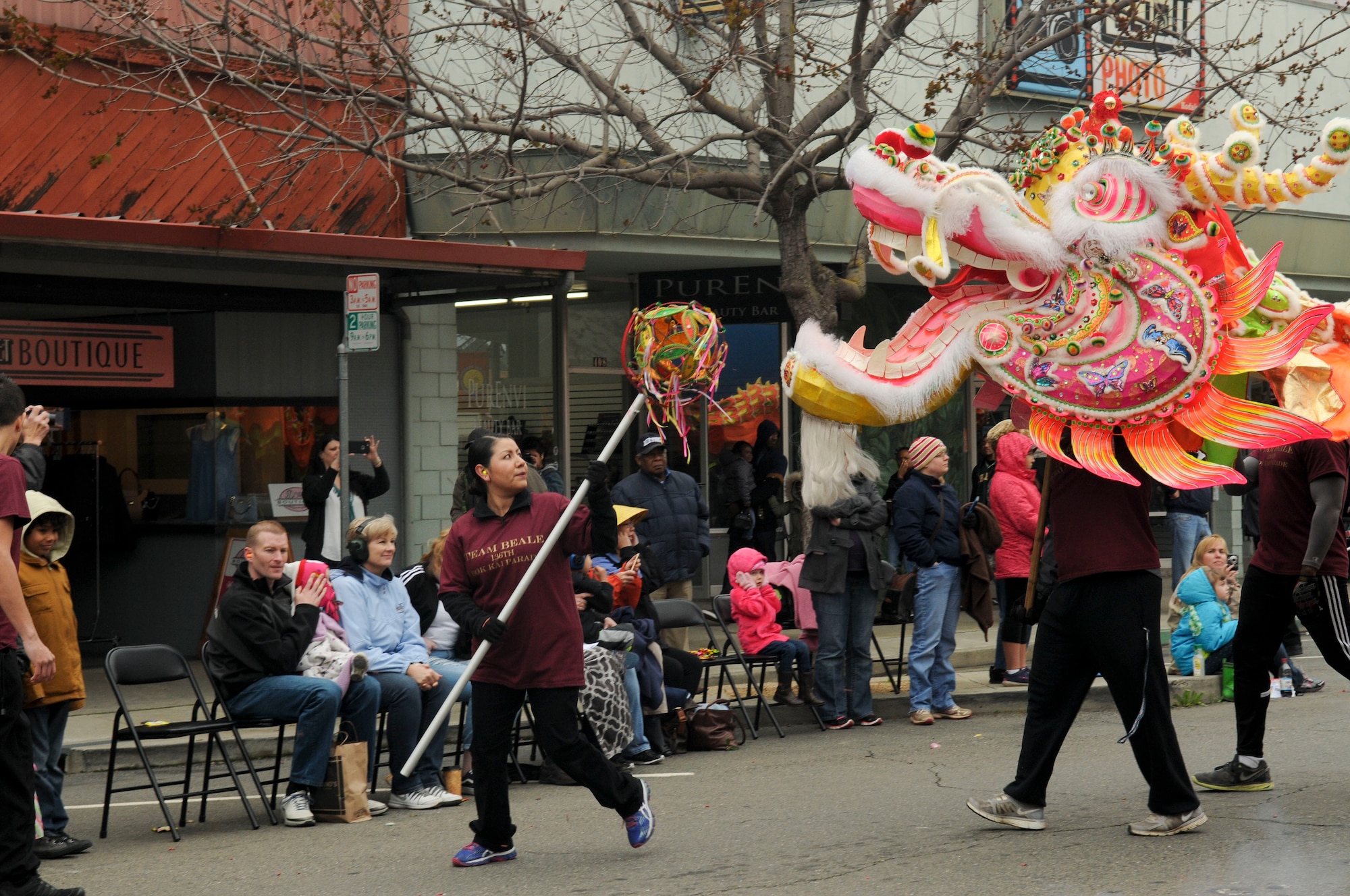 2nd Lt. Nancy Gately leads The “Hong Wan Lung” Dragon down the street in Marysville, California, Mar. 12, 2016. Beale Air Force Base volunteers brought the dragon to life for the Bok Kai parade. Beale has been a part of the parade for more than 20 years. The festival celebrates the Chinese Water God of the North. 