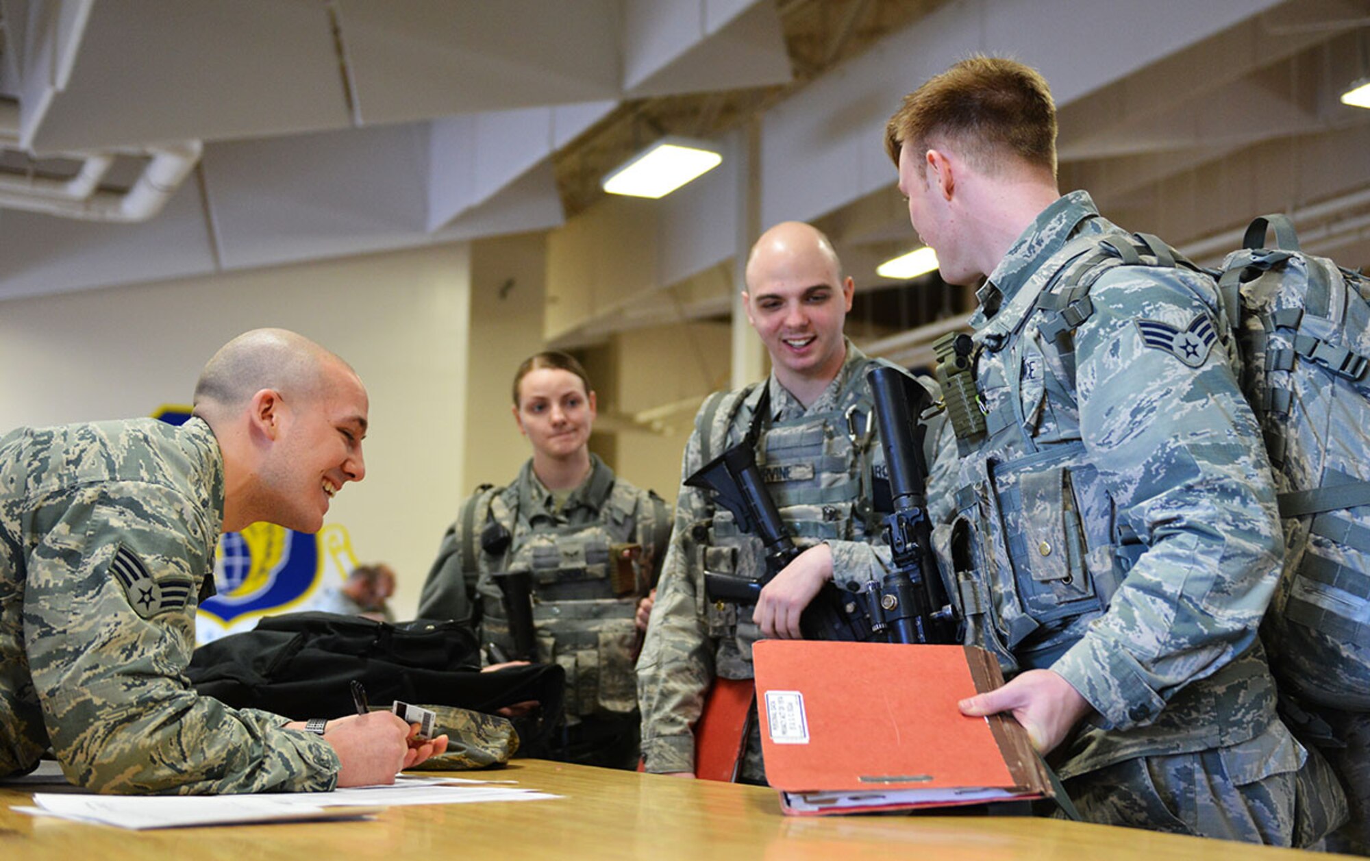 Senior Airman Allen De Palmer, a travel center clerk with the Traffic Management Office, augments the 773d Logistics Readiness Squadron and processes 673d Security Forces Squadron members as part of the Mission Support Group’s annual mobility exercise, March 10 at the Joint Mobility Center. This particular iteration of the exercise was the first time they processed people, not just cargo. (U.S. Air Force photo by Airman 1st Class Kyle Johnson)