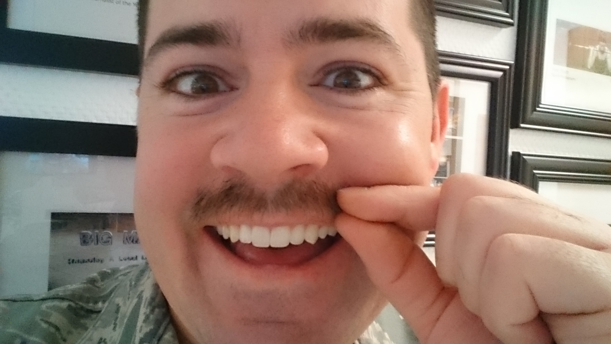 U.S. Air Force Staff Sgt. Christopher Ruano, a 52nd Fighter Wing public affairs photojournalist, takes a selfie with his mustache, Gregory, in honor of Mustache March, March 14, 2016. Mustache March is an Air Force tradition that started during the Vietnam War and is still practiced today. (U.S. Air Force selfie by Staff Sgt. Christopher Ruano/Released)