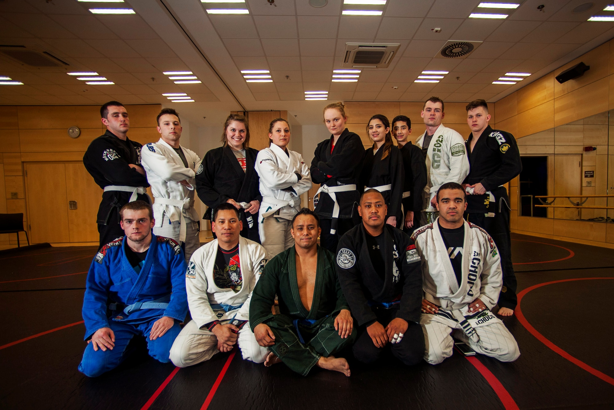 The Spangdahlem Brazilian Jiu Jitsu class poses for a group photo in the Eifel Powerhaus at Spangdahlem Air Base, Germany, March 8, 2016. The class takes place on Mondays and Tuesdays from 6:30 to 7 p.m., and is free and open to all base community members. (U.S. Air Force photo by Airman 1st Class Timothy Kim/Released) 