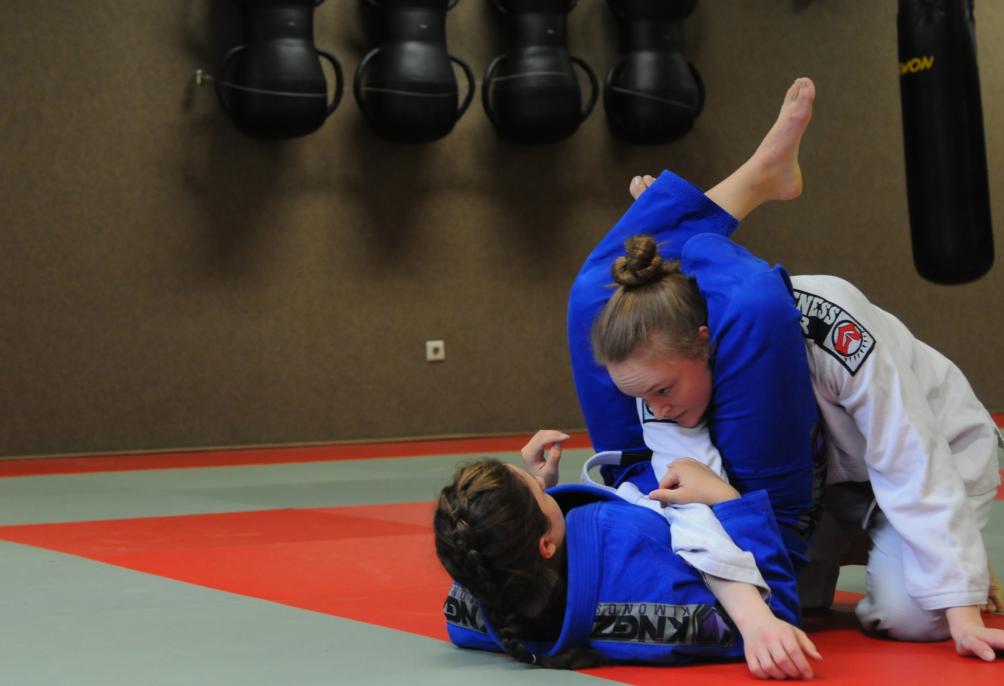 Mariah Johnson, a 52nd Force Support Squadron value-added tax officer, left, and U.S. Air Force Senior Airman Catherine Westervelt, a 52nd Fighter Wing legal office paralegal, both members of the Spangdahlem Brazilian Jiu Jitsu class, practice before Johnson’s first match at the Submissao competition in Karlsruhe, Germany, Feb. 20, 2016. Johnson started practicing Jiu Jitsu during November 2015. (Courtesy photo)