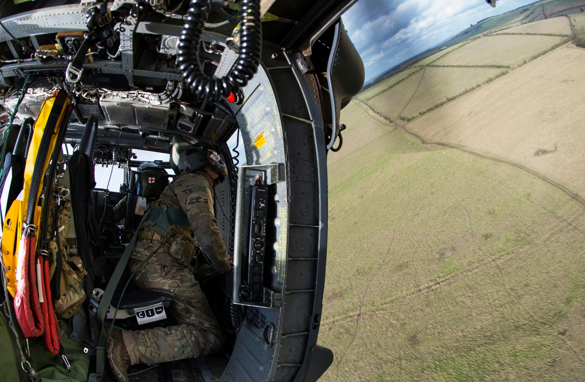 Staff Sgt. Joseph Bland, 56th RQS special missions aviator, scans the terrain outside an HH-60G Pave Hawk during exercise Voijek Valour at Salisbury Plain, England, March 4, 2016. The 56th RQS from Royal Air Force Lakenheath and the 7th Special Operations Squadron from RAF Mildenhall flew to Hullavington Airfield to train alongside the British Army and Royal Air Force. (U.S. Air Force photo/Staff Sgt. Emerson Nuñez) 