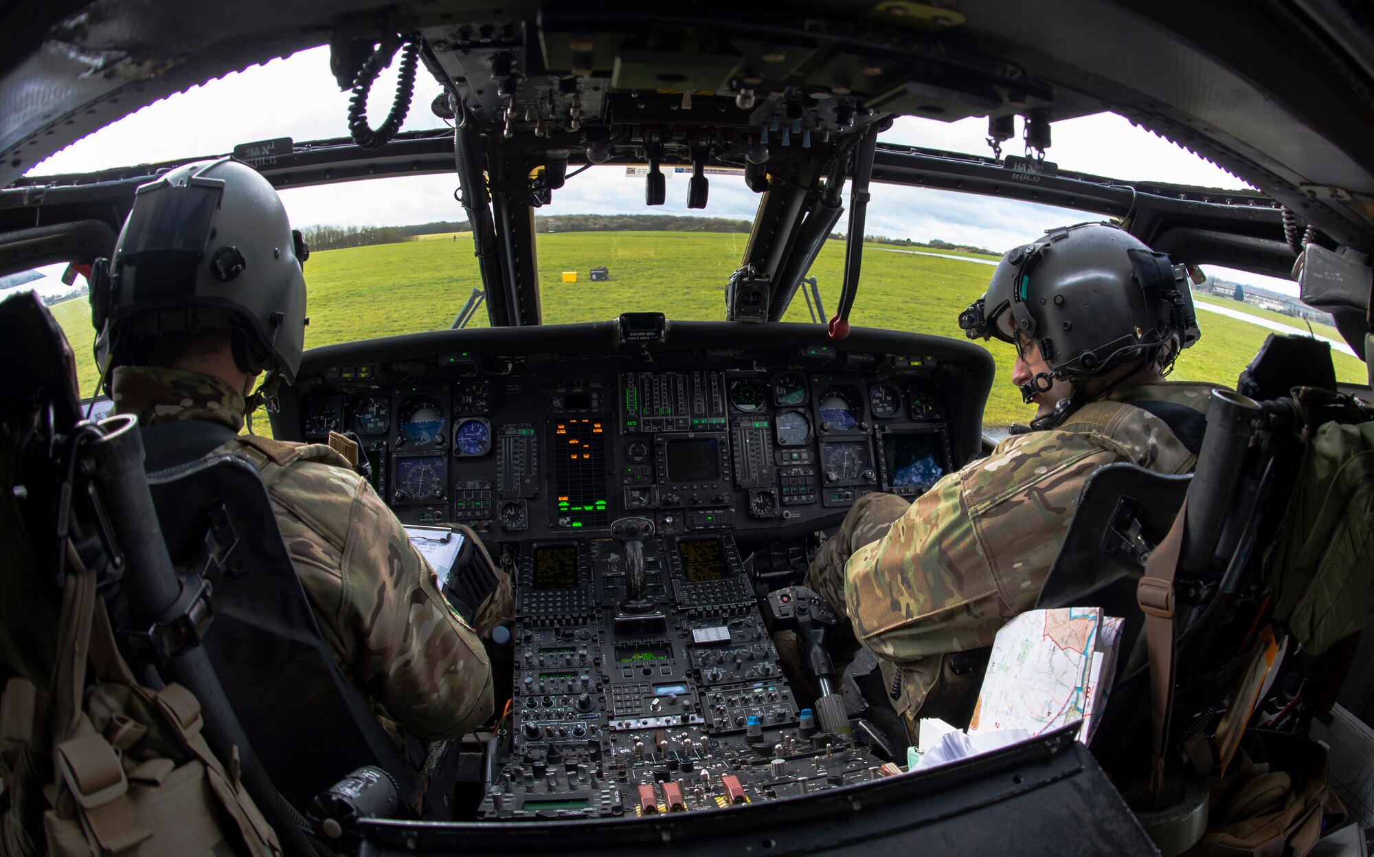 1st Lt. Andrej Pulver, 56th Rescue Squadron co-pilot, left, and Capt. John Golden 56th RQS pilot, perform a pre-flight check during exercise Voijek Valour at Hullavington Airfield, England, March 2, 2016. The exercise included six helicopters, 250 British soldiers and more than a dozen jets conducting scenarios across Salisbury Plain. (U.S. Air Force photo/Staff Sgt. Emerson Nuñez)