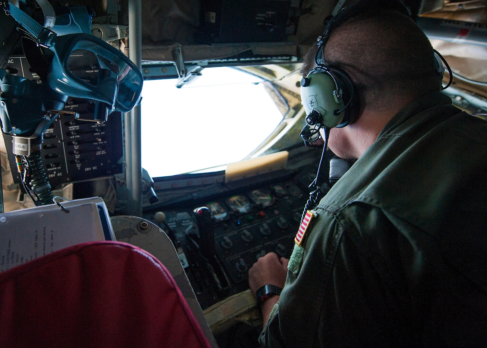 Senior Airman Luke Pommier, 91st Air Refueling Squadron, watches for F-35A Lightning II receivers from the boom pod of a KC-135 Stratotanker during a refuel mission over the Gulf of Mexico near Eglin Air Force Base, Fla. March 4.  During the morning mission, local media and 33rd Fighter Wing F-35 maintainers watched as the MacDill Air Force Base KC-135 crew offloaded approximately 48,100 pounds of jet fuel to seven F-35As.  (U.S. Air Force photo/Ilka Cole)