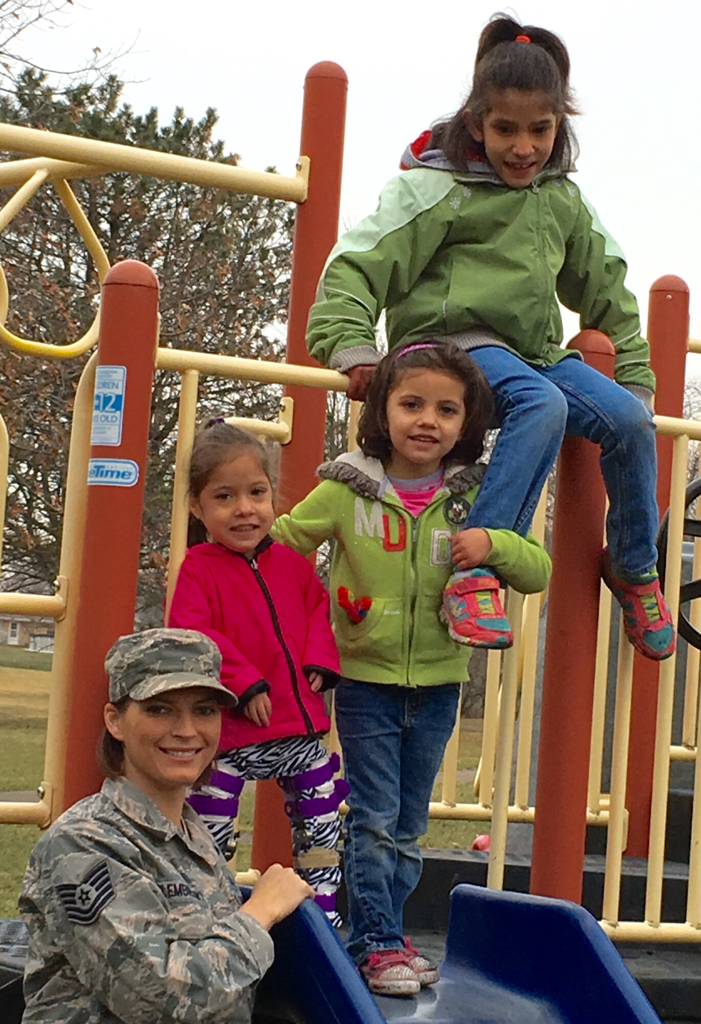 Tech. Sgt. Amanda Golembiewski with her three daughters, Grace, Allie, and Emma enjoy a day at the playground. (Contributed photo)