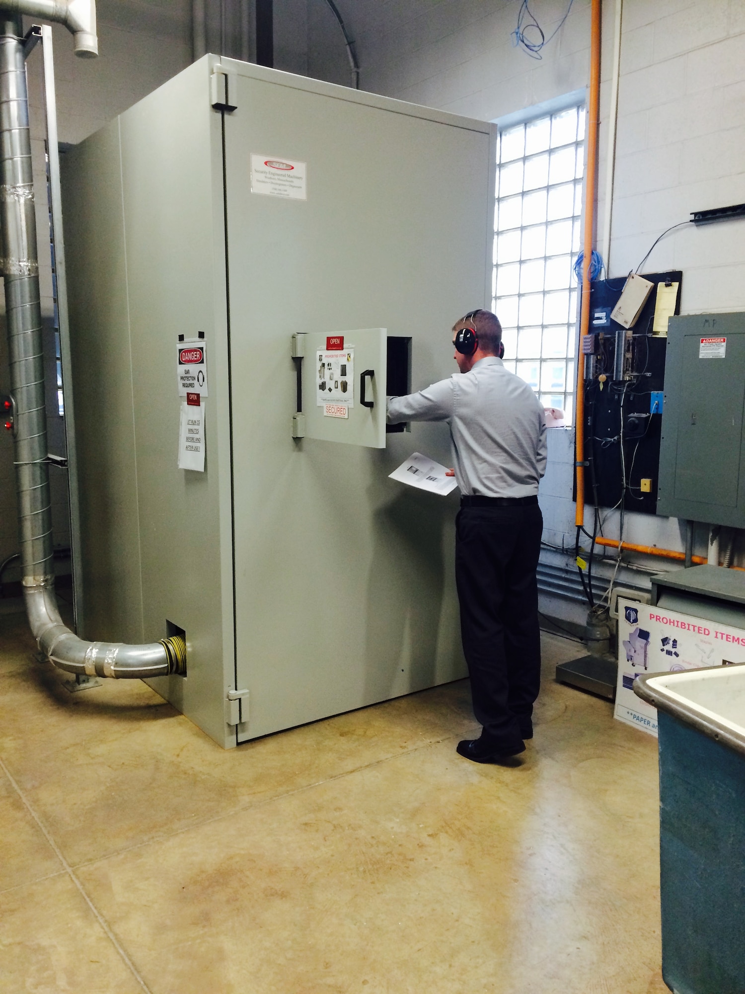 Justin Taulbee, Information Security, utilizes the disintegrator to destroy paper and compact disk-related material. (Contributed photo)