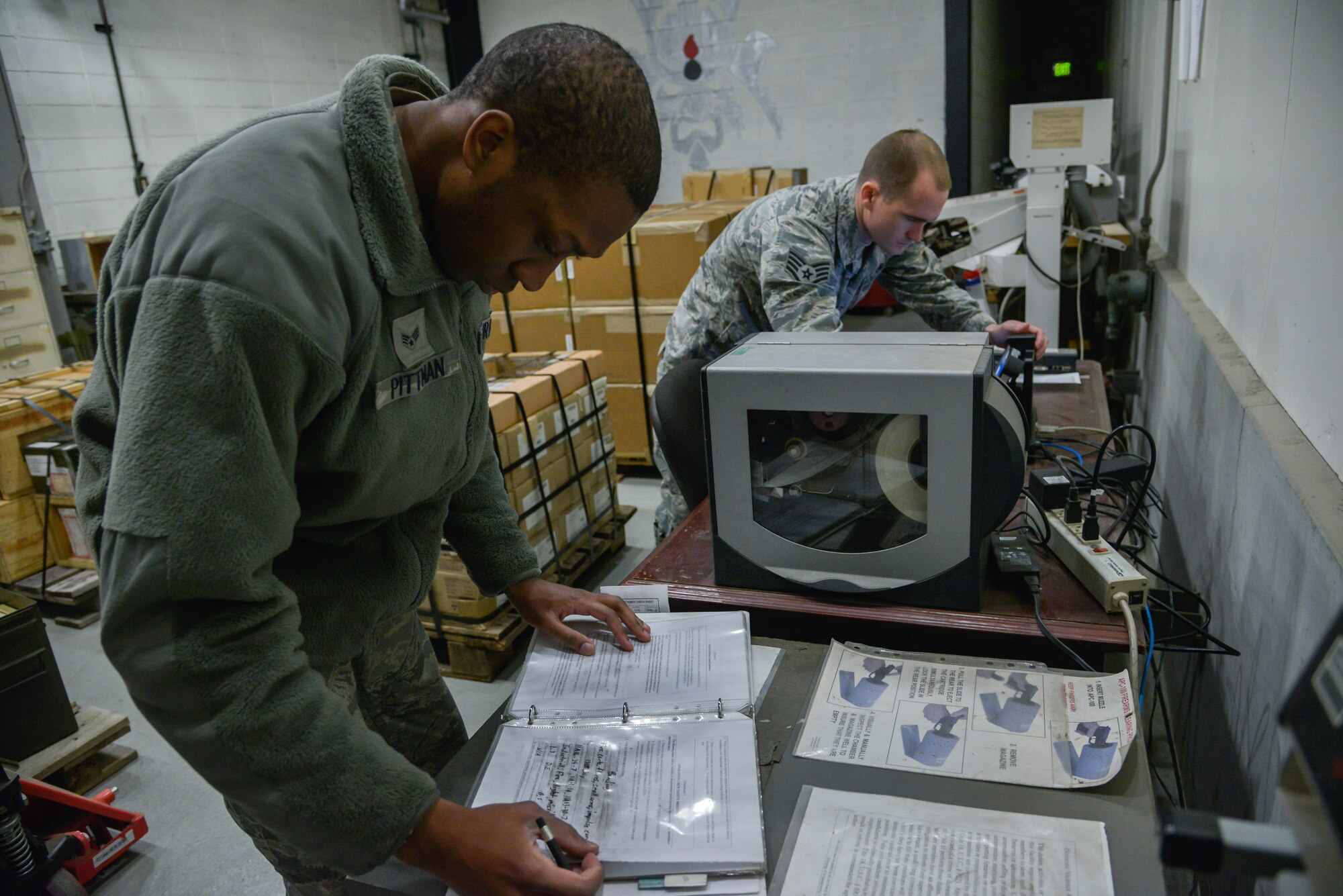 Senior Airman Damien Pittman, 374th Maintenance Squadron Munitions Flight munitions stockpile surveillance crewmember, updates a crew book prior to an explosive operation inspection at Yokota Air Base, Japan, Feb. 24, 2016. The inspections ensure that all assets are safe for use and function as designed. (U.S. Air Force photo by Senior Airman David Owsianka/Released)