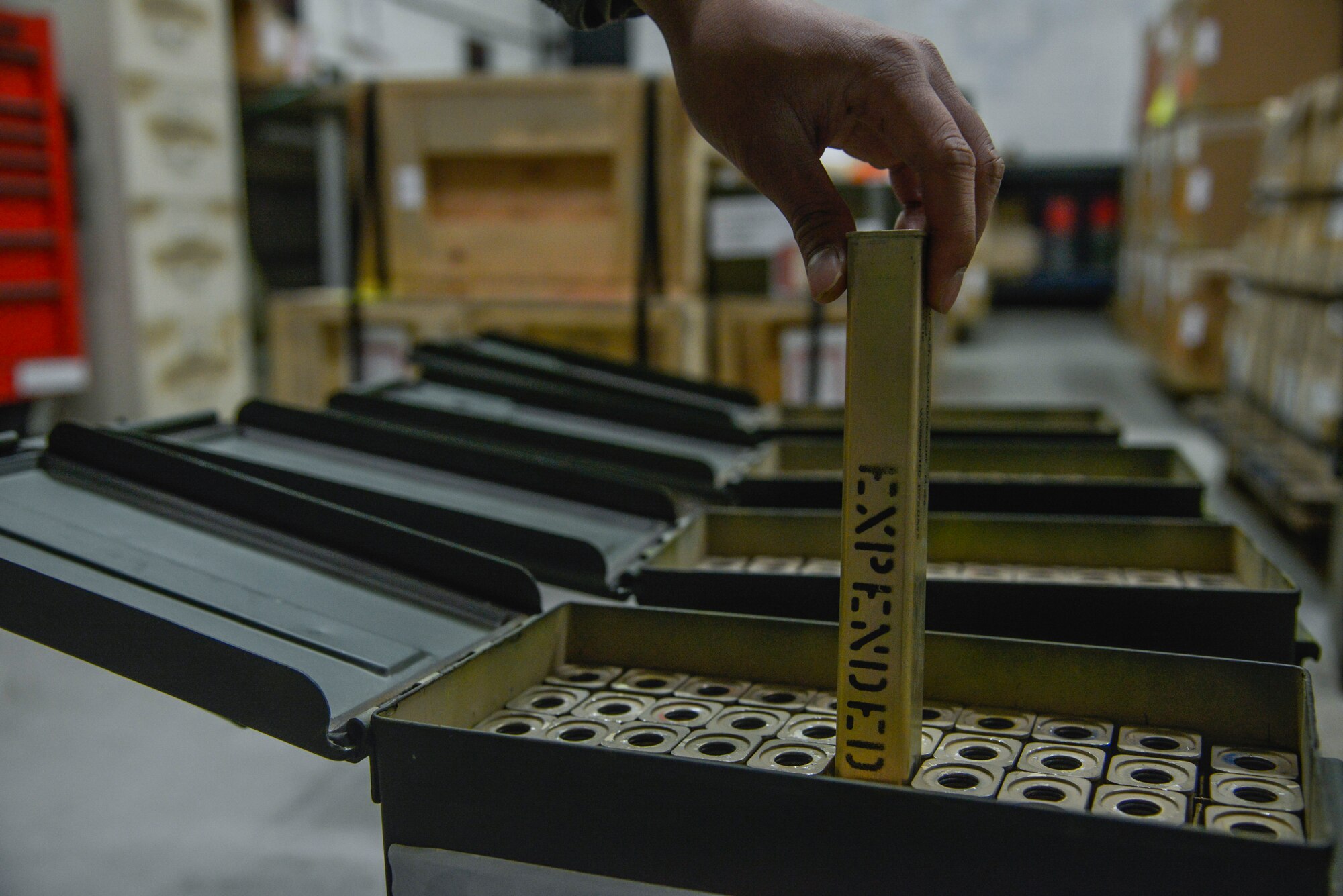 Senior Airman Rhodney Siddayao, 374th Maintenance Squadron Munitions Flight munitions inspector, places an expended aircraft M-206 countermeasure flare in a container at Yokota Air Base, Japan, Feb. 24, 2016. The C-130s use M-206 countermeasure flares to counter infrared homing surface-to-air missiles or air-to-air missiles. (U.S. Air Force photo by Senior Airman David Owsianka/Released)