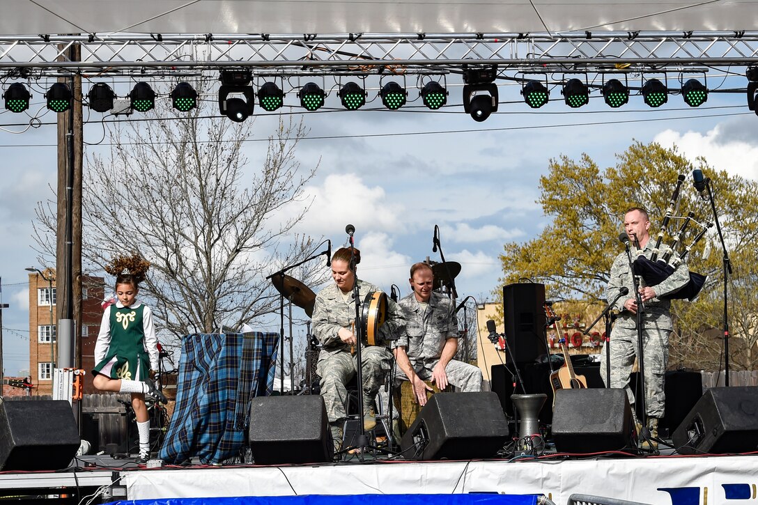 Erin Hixson (left), Tir Conaill Academy of Irish Dance student, dances on stage with the United States Air Force Band’s Celtic Aire during a performance at the Wichita Falls Irish Street Festival in Wichita Falls, Texas, March 12, 2016. The band is the premier Celtic and folk ensemble of the U.S. Air Force Band. (U.S. Air Force photo by Senior Airman Ryan J. Sonnier/RELEASED)