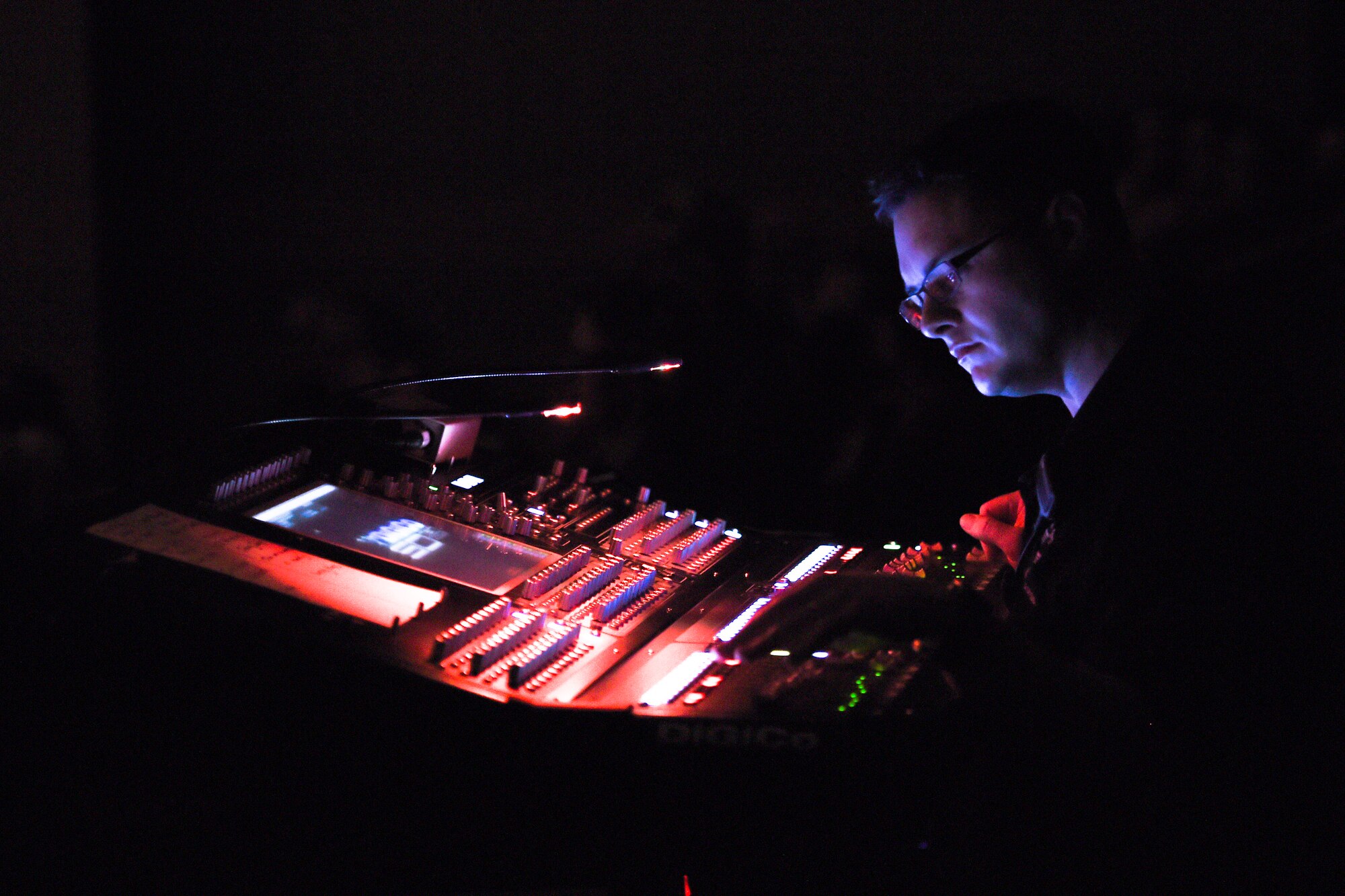 Senior Master Sgt. Adam Dempsey, United States Air Force Band’s Celtic Aire sound engineer, operates a soundboard during a performance at the Cultural Activities Center in Temple, Texas, March 8, 2016. This show was part of a North Texas tour from March 4 – 12. (U.S. Air Force photo by Senior Airman Ryan J. Sonnier/RELEASED)